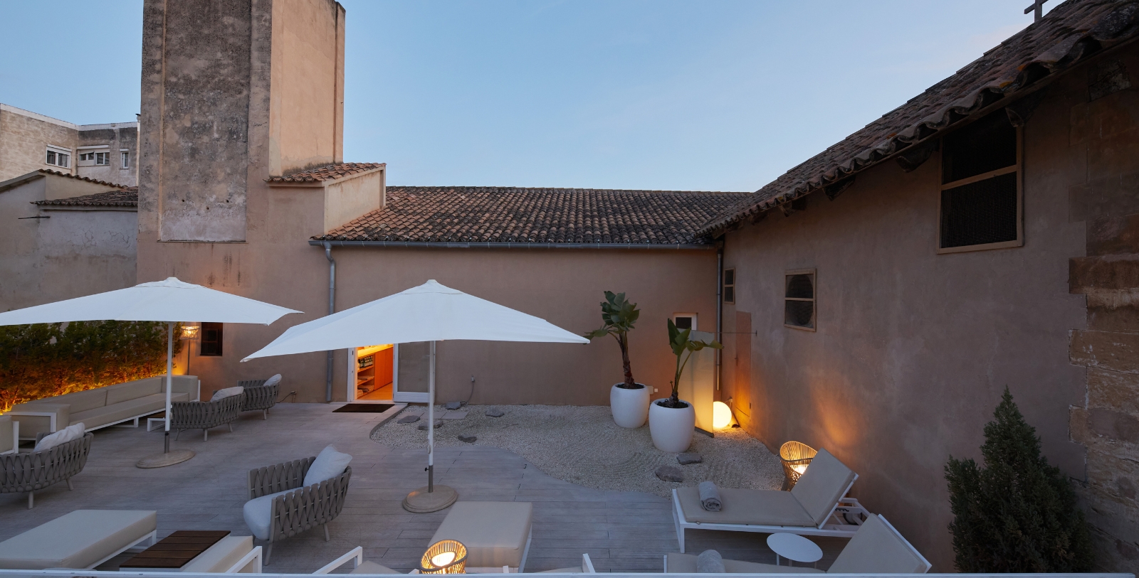 a patio with chairs and umbrellas