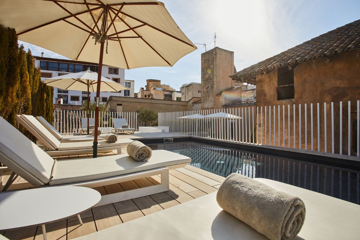 a pool with a towel and umbrella