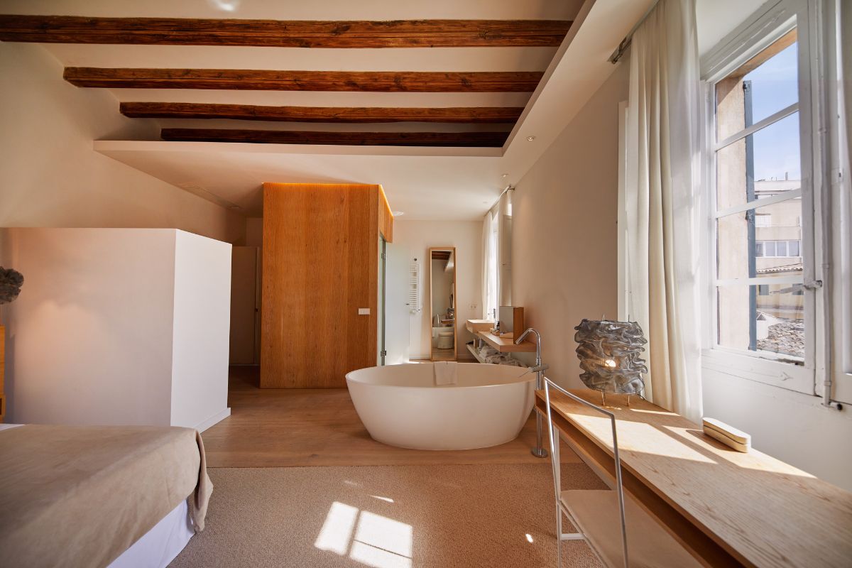a bathroom with a tub and a wood ceiling