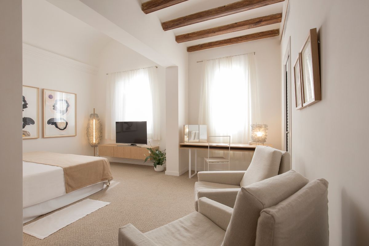 a room with a bed and a television