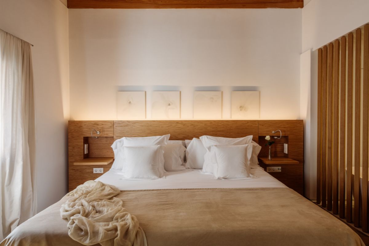a bed with white pillows and a blanket on it