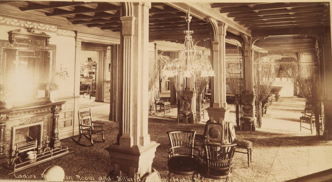 a room with chairs and chandeliers