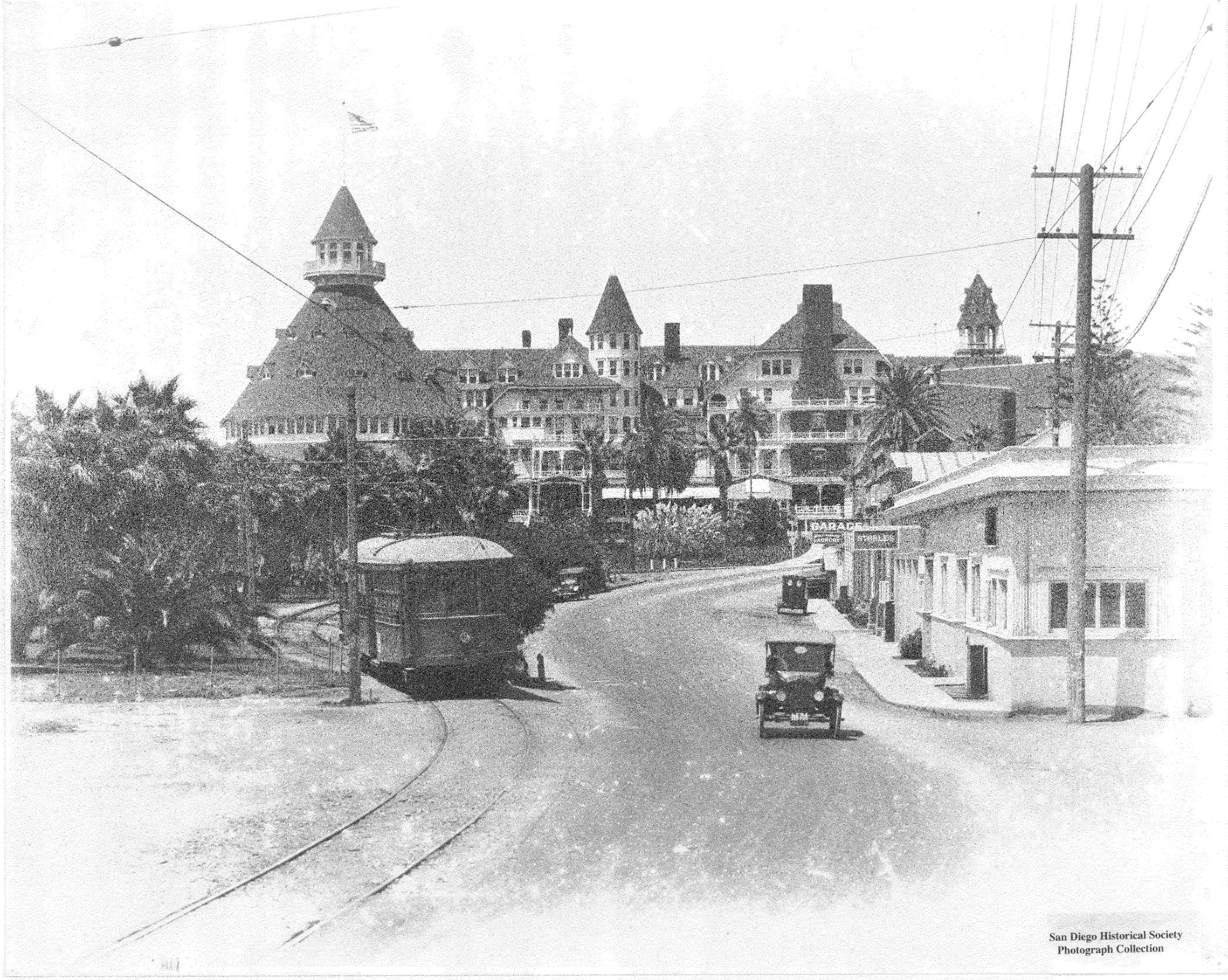 a black and white photo of a street with buildings and cars