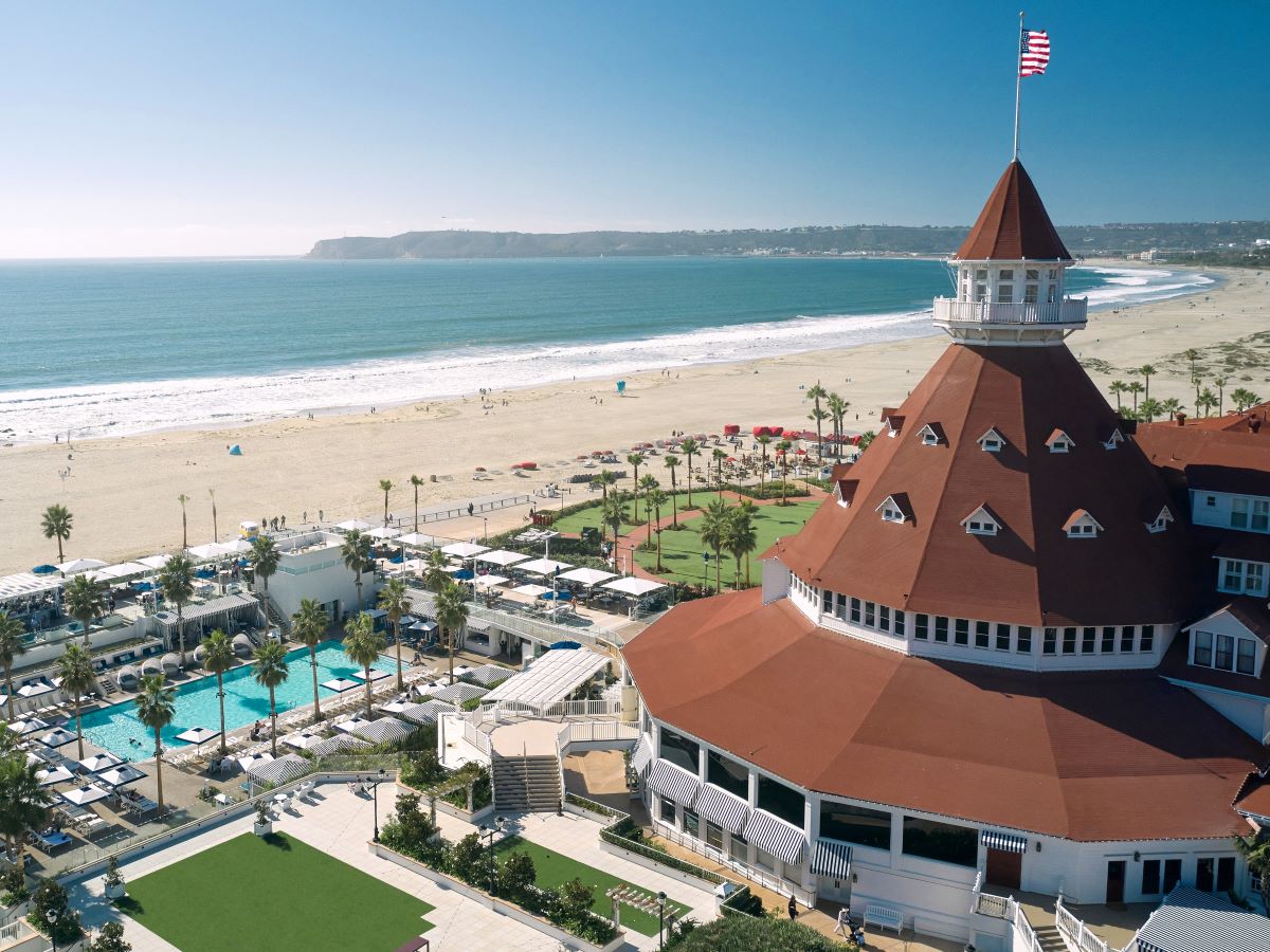 a building with a flag on top and a beach