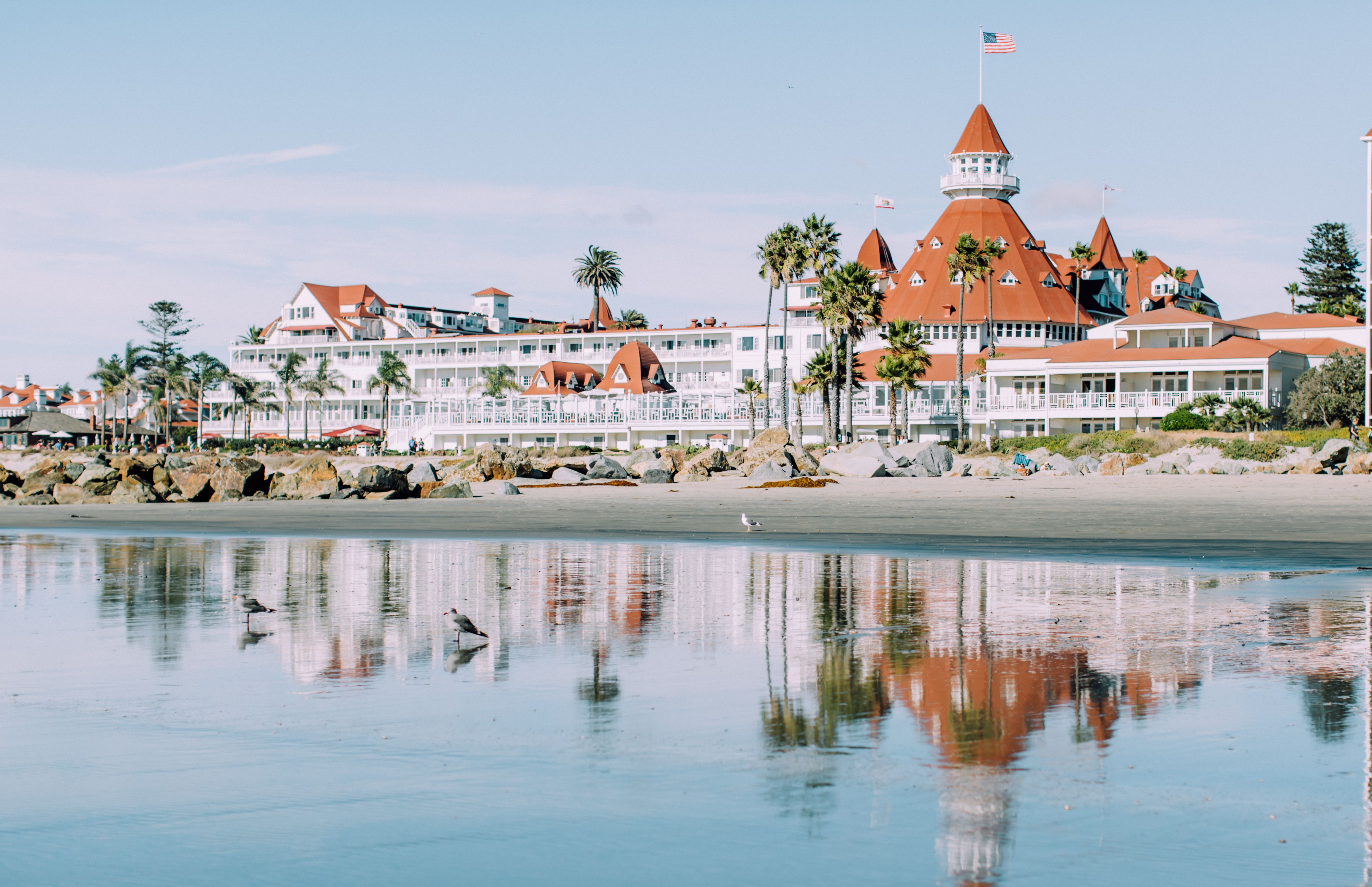 a beach with a building and a flag on it