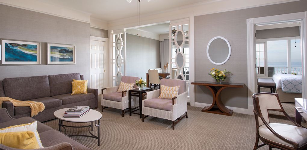 a room with a couch and chairs
