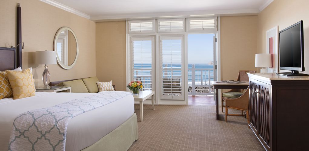 a room with a bed and a table and chairs