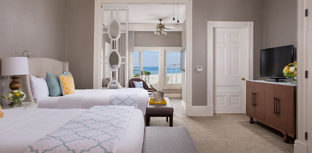 a room with two beds and a window