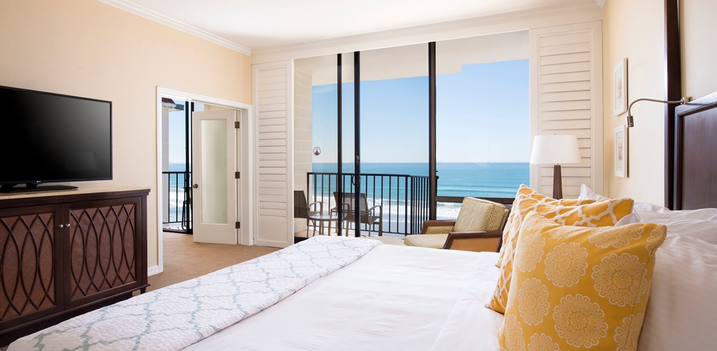 a bedroom with a view of the ocean