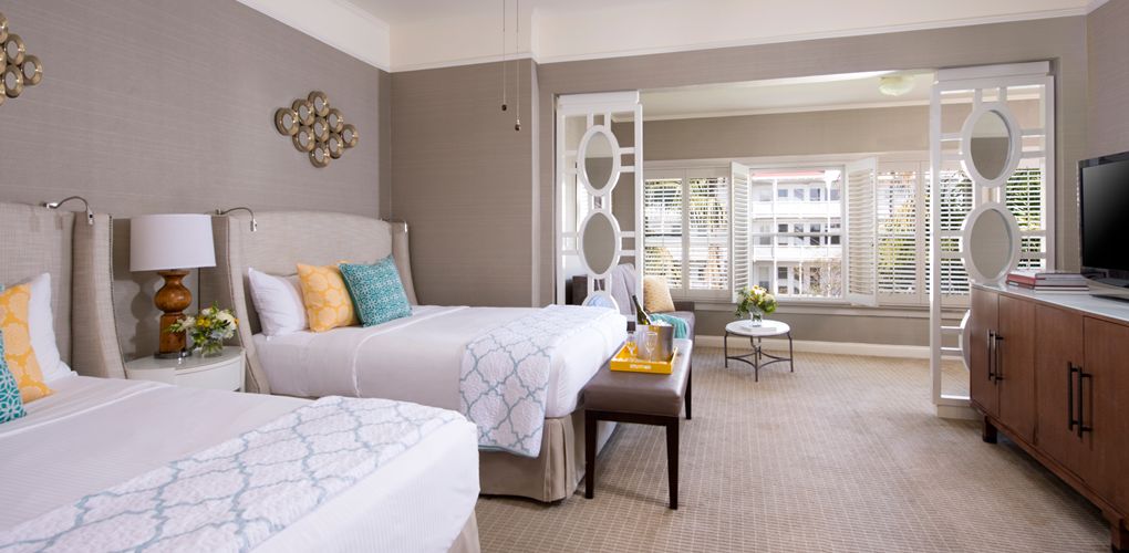 a room with two beds and a table