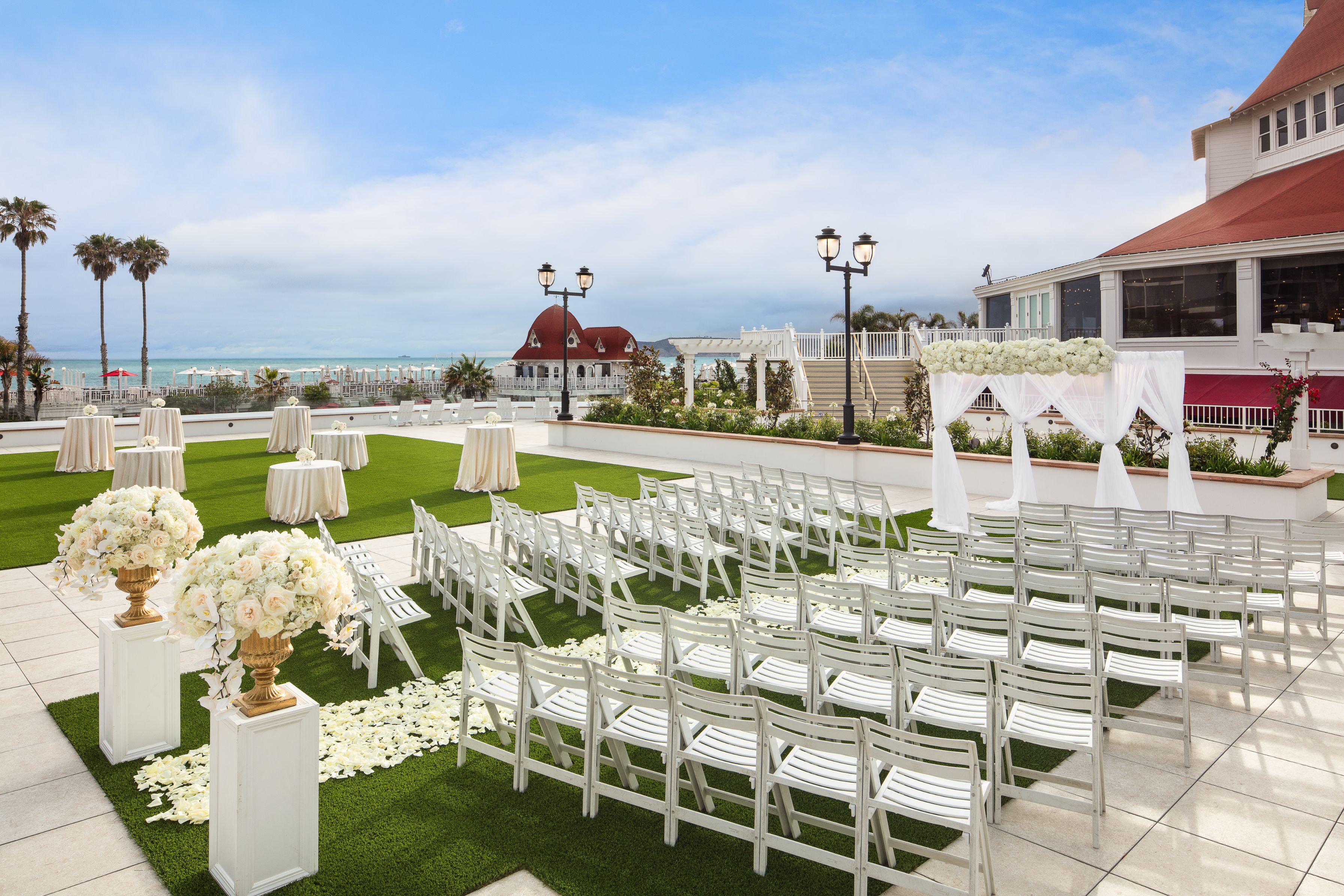 a wedding ceremony area with chairs and tables