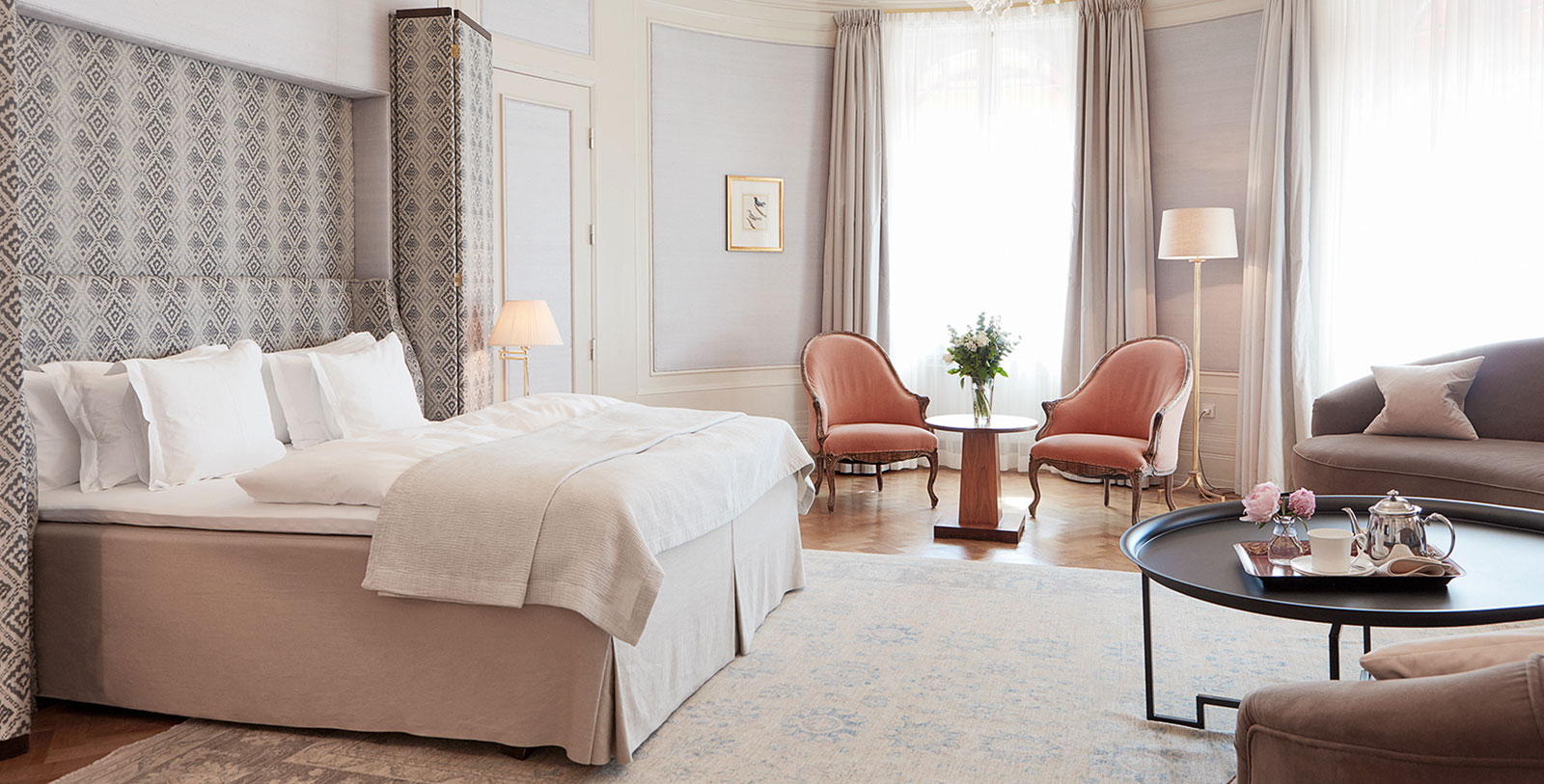 a bedroom with a bed and chairs