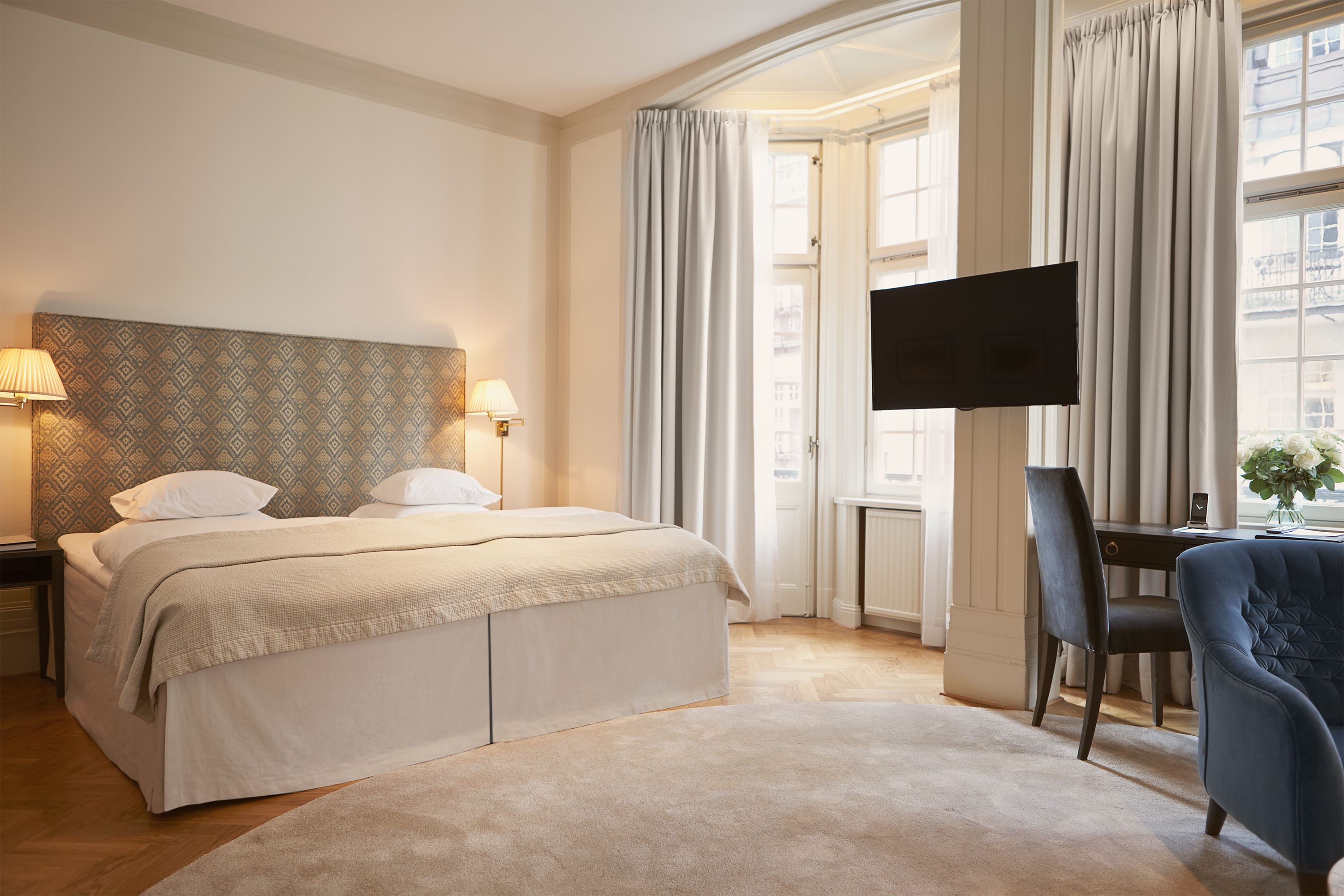 a bedroom with a bed and a chair
