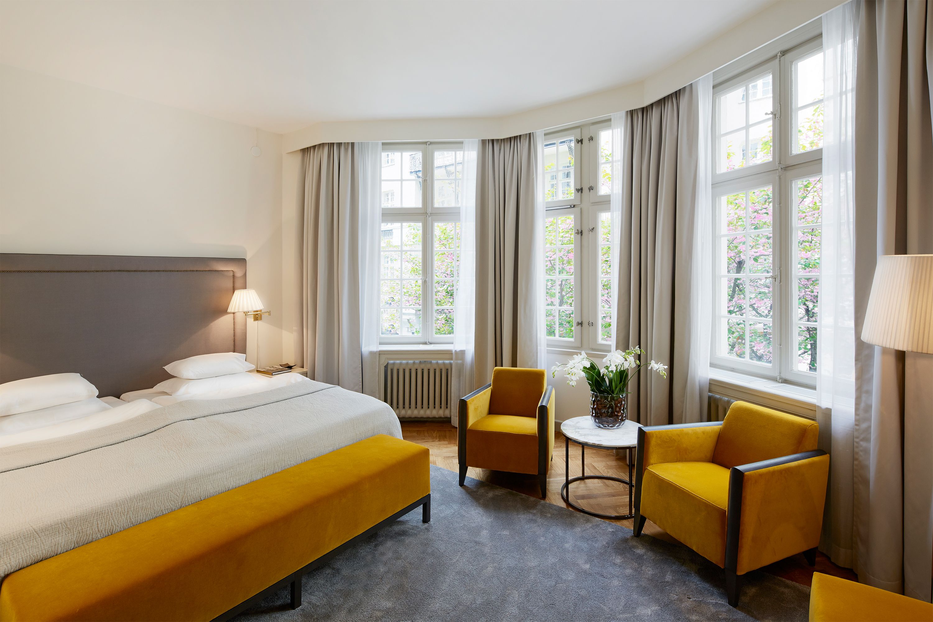 a bedroom with a bed and chairs