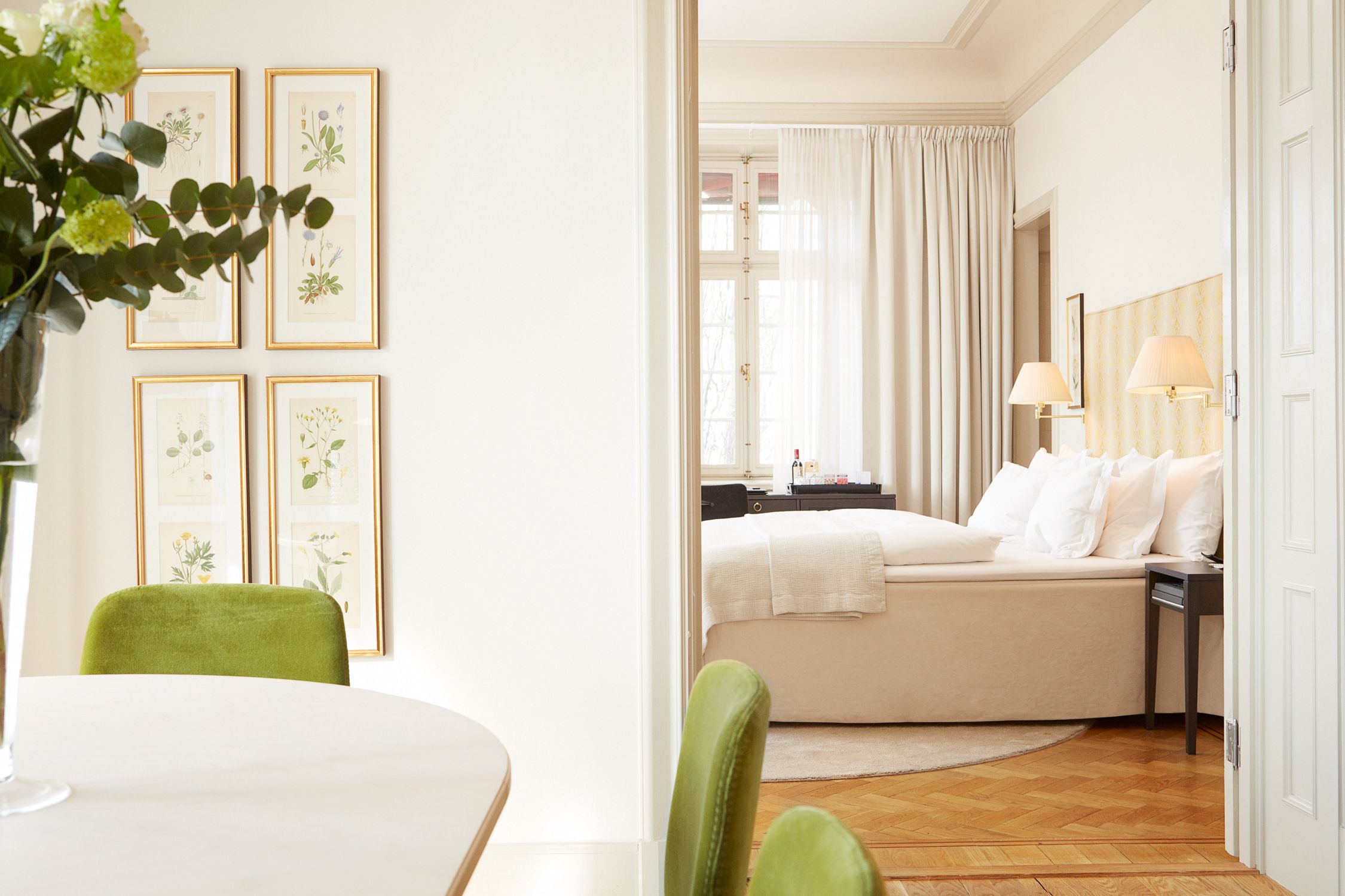 a bedroom with a table and chairs