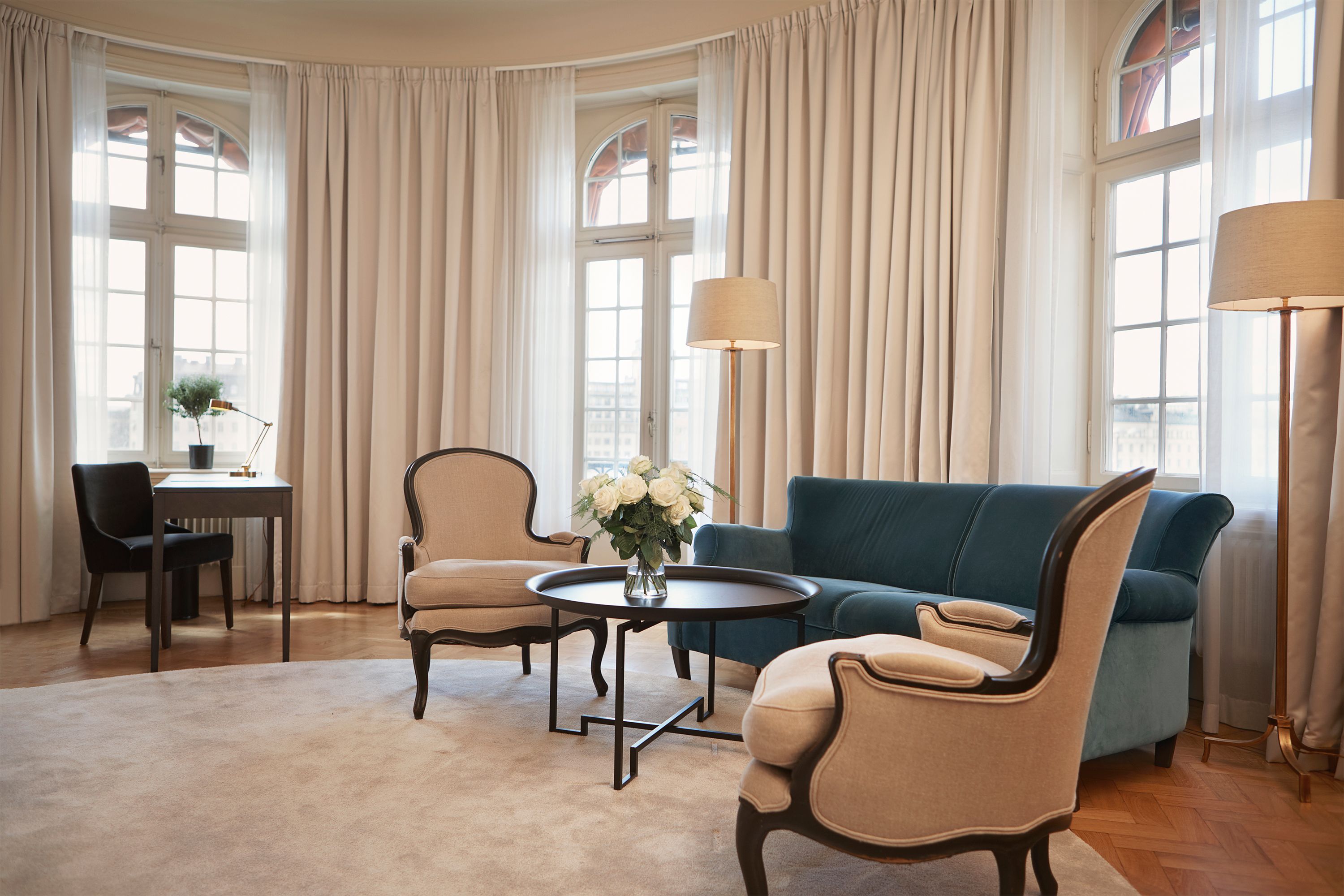 a living room with a couch and chairs