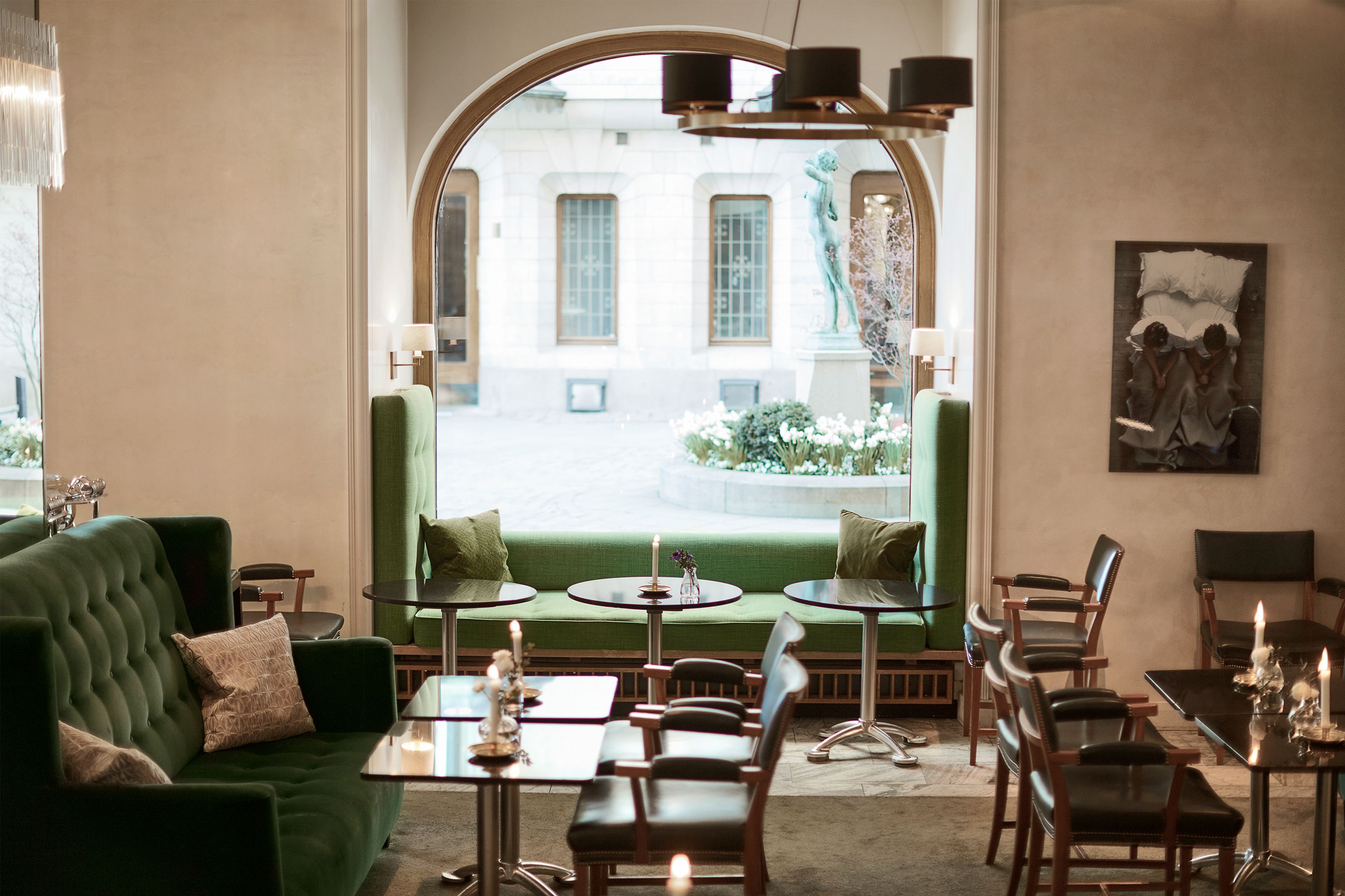 a room with a green couch and tables