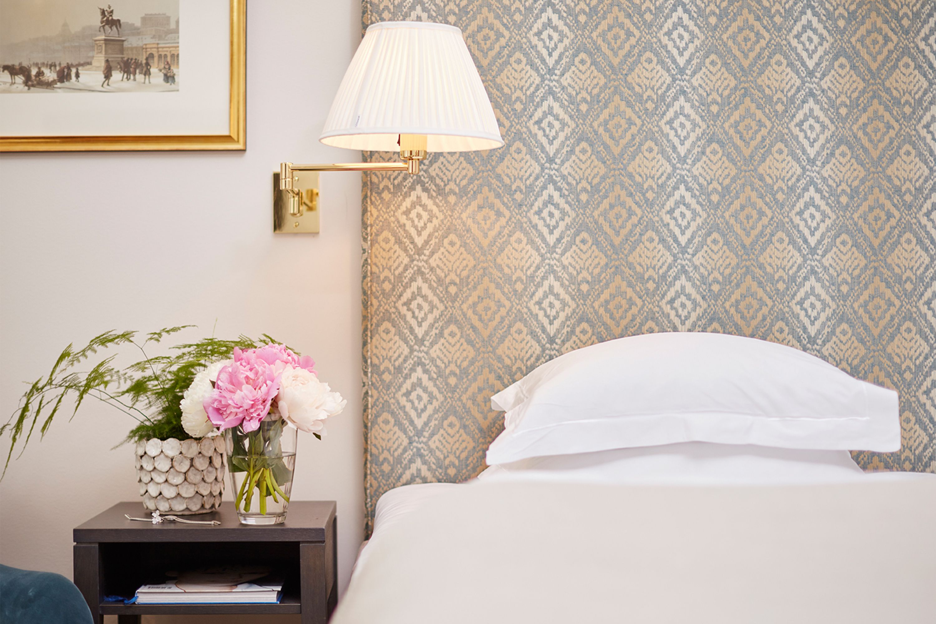 a lamp next to a bed