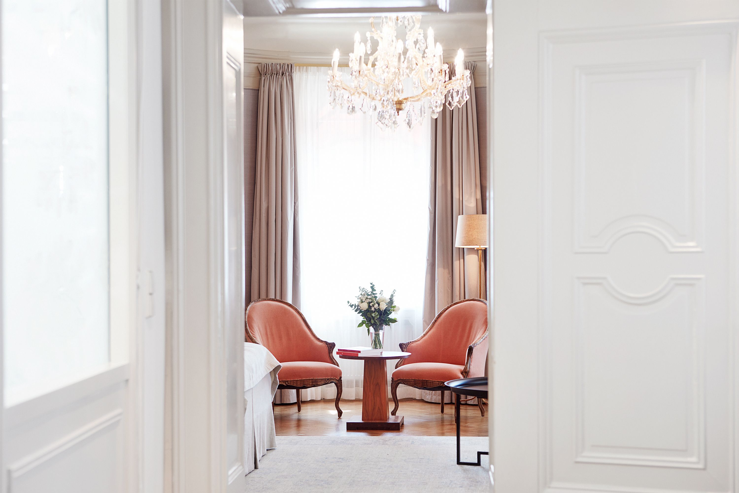 a room with a chandelier and chairs