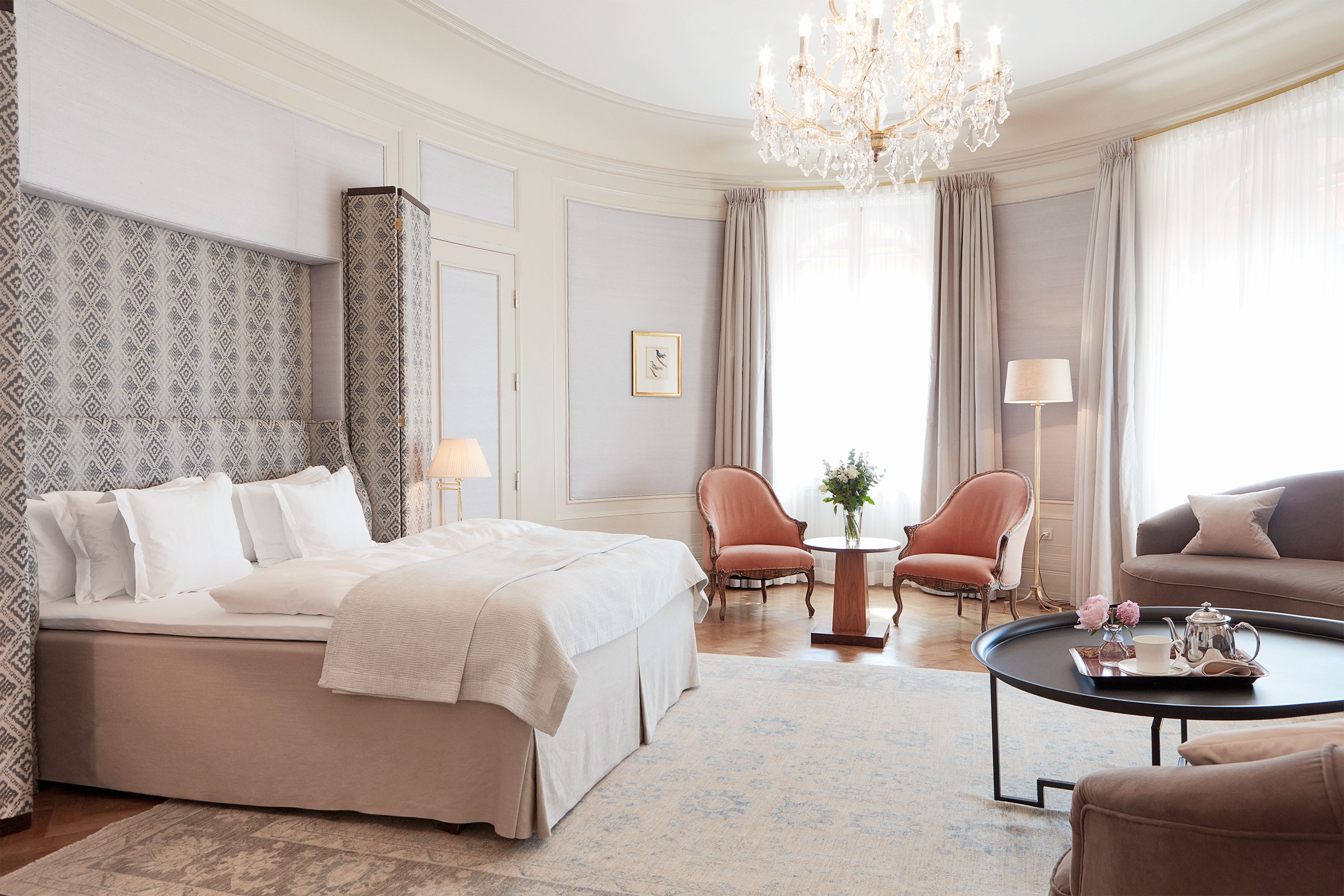 a bedroom with a chandelier and a bed