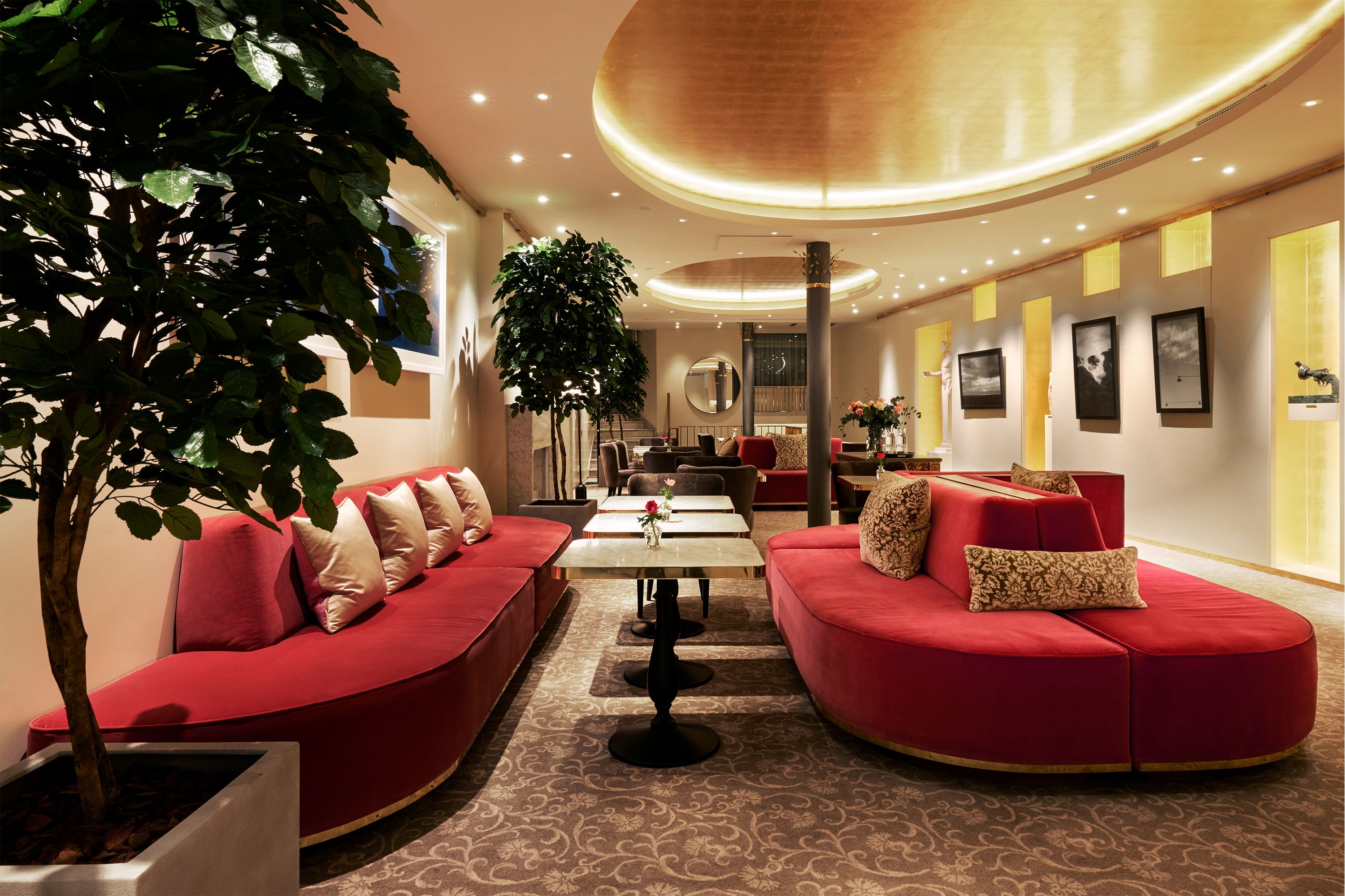 a room with red couches and tables