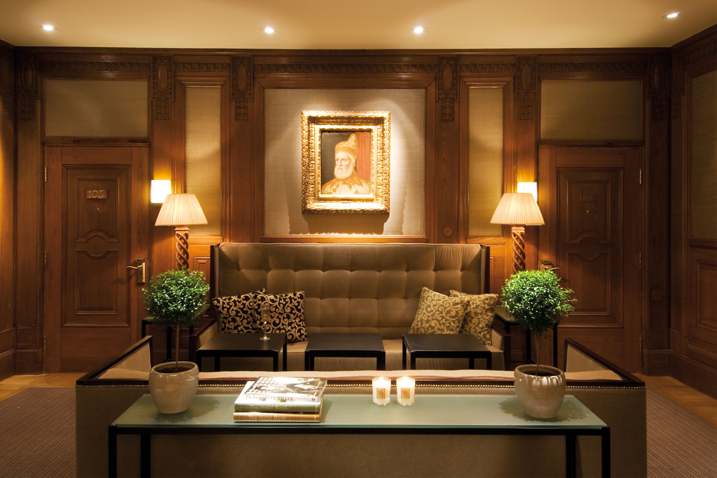 a room with a couch and a painting on the wall