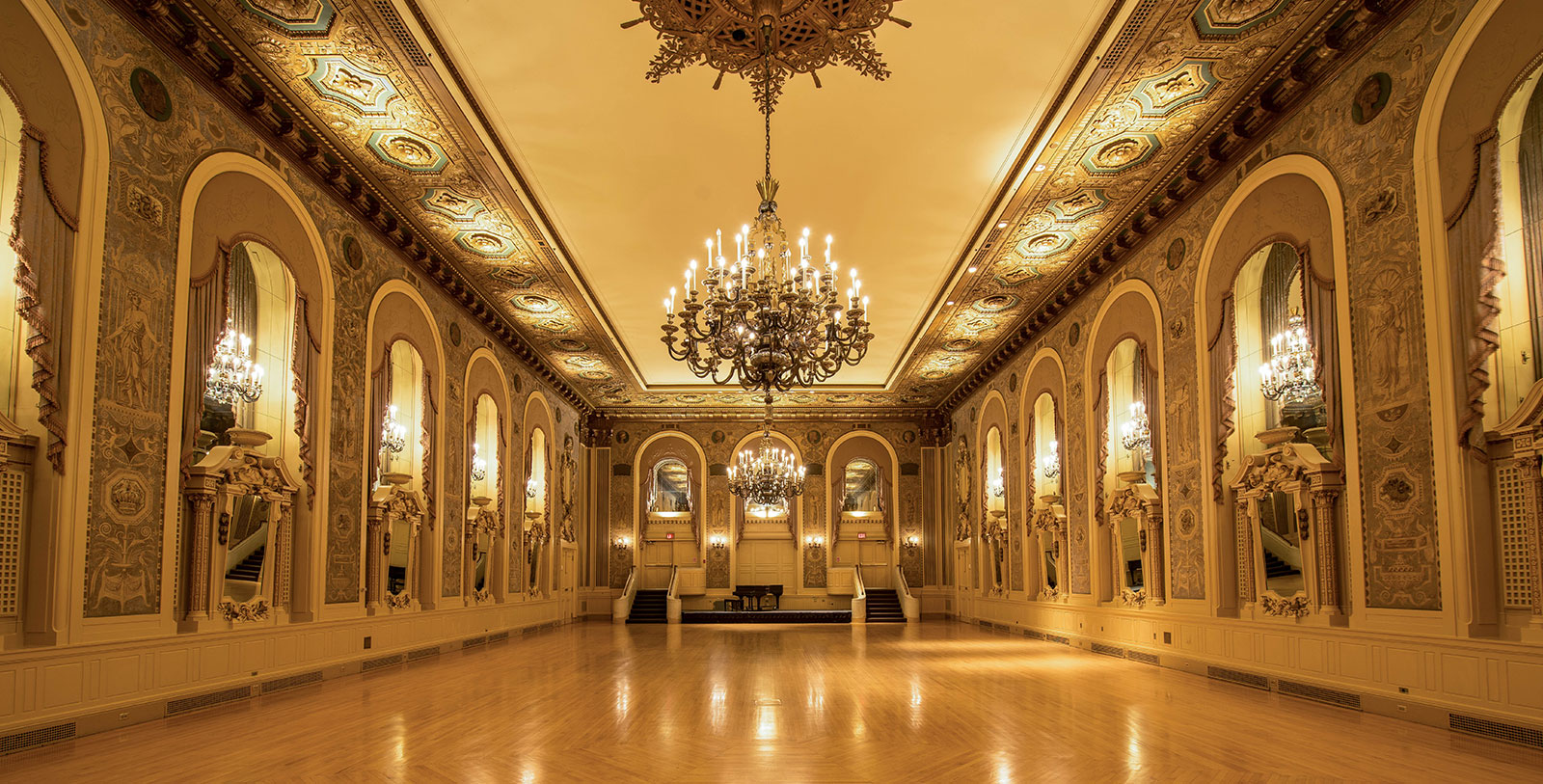a large room with chandelier and mirror walls