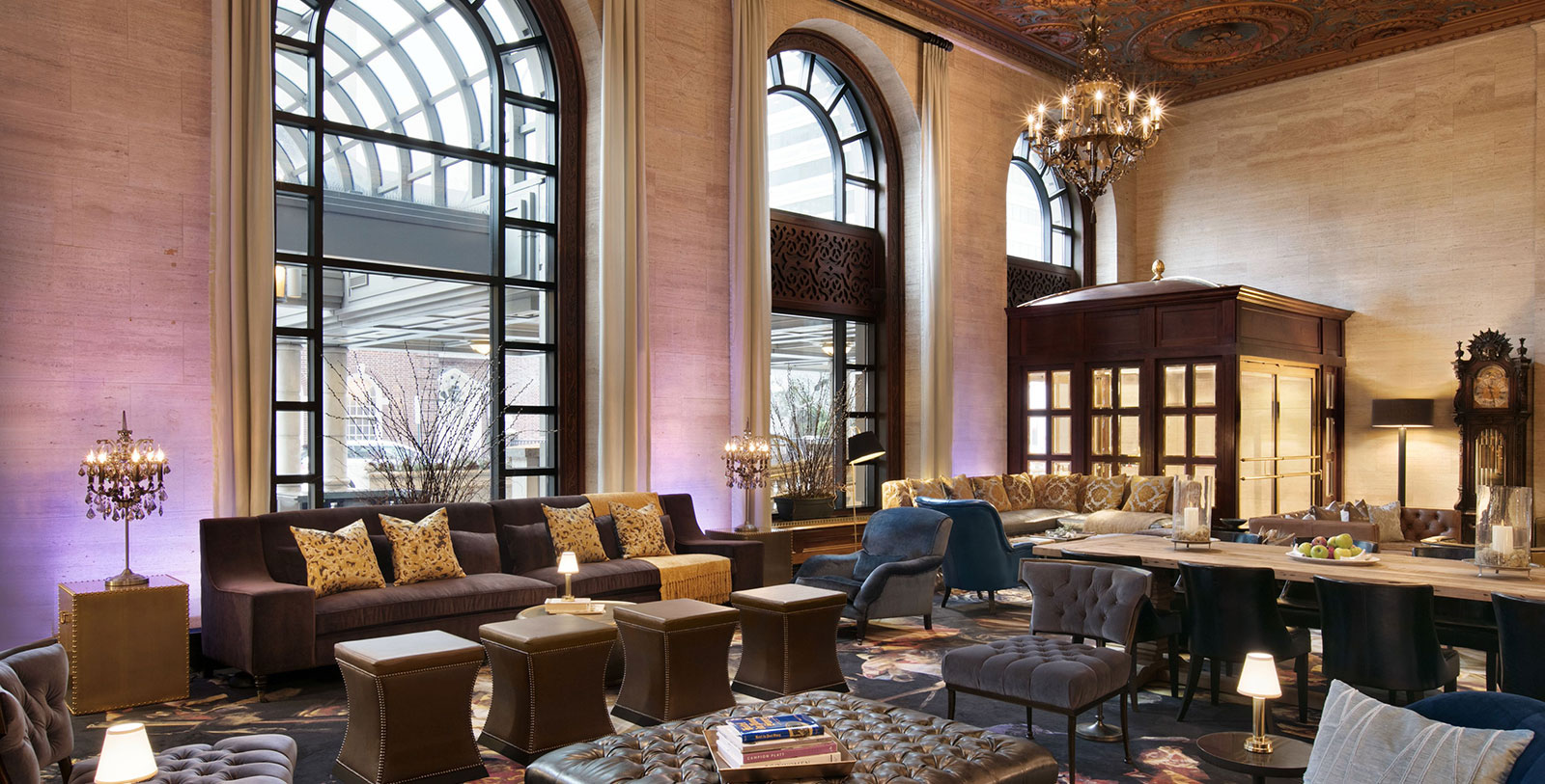 a large room with a large chandelier and couches