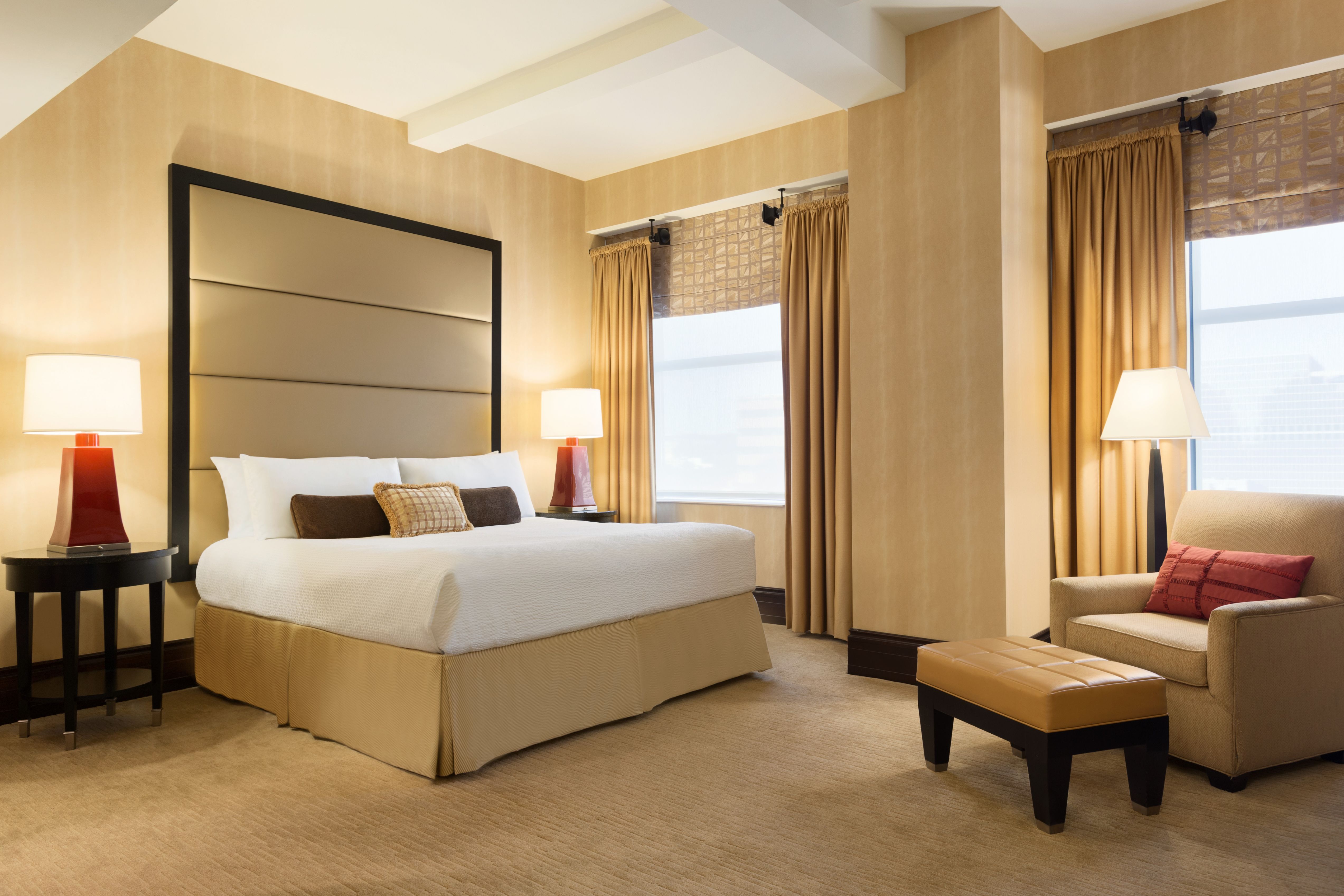 a bedroom with a bed and a chair