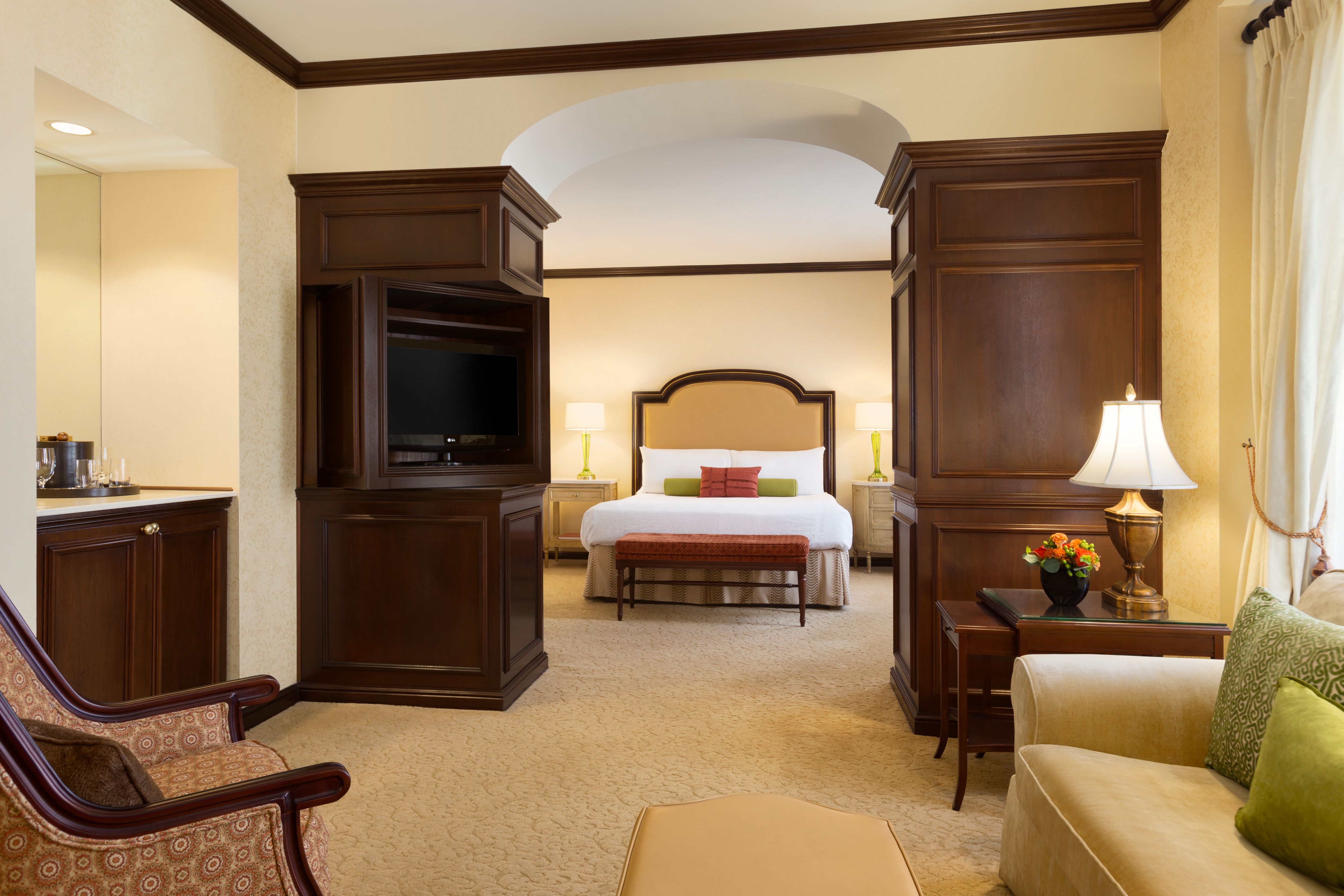 a room with a bed and a television
