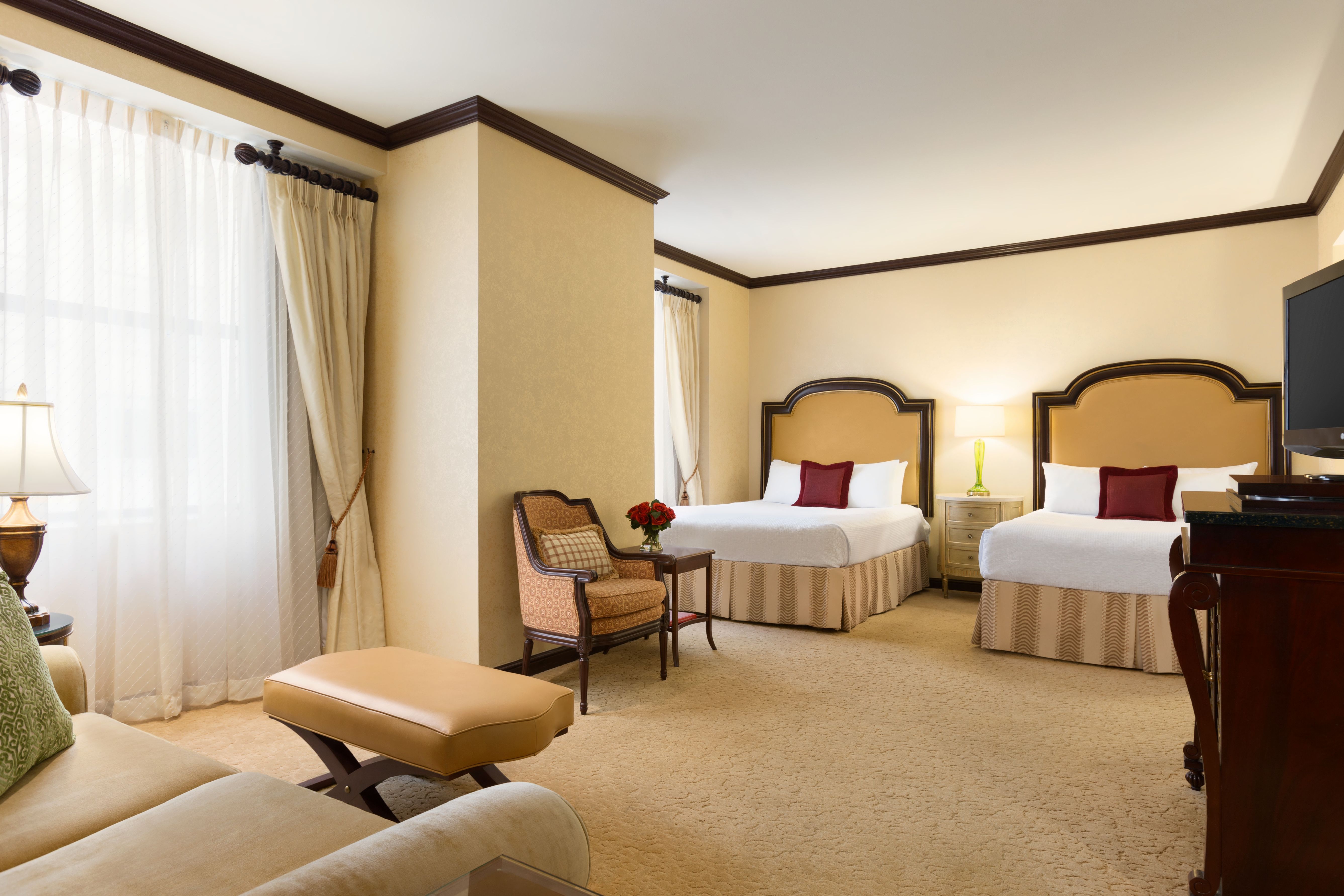 a room with two beds and a chair