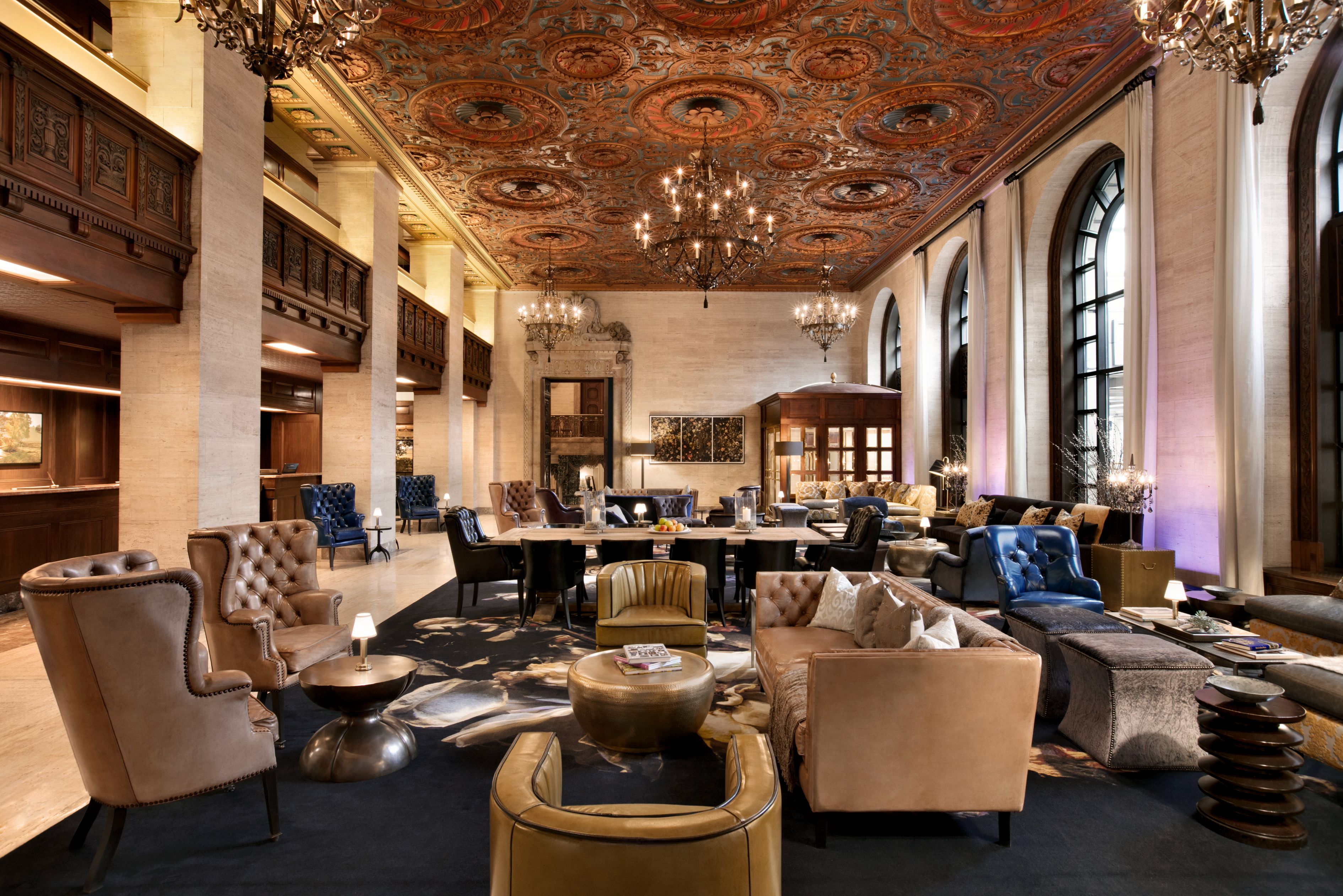 a large room with a large chandelier and couches