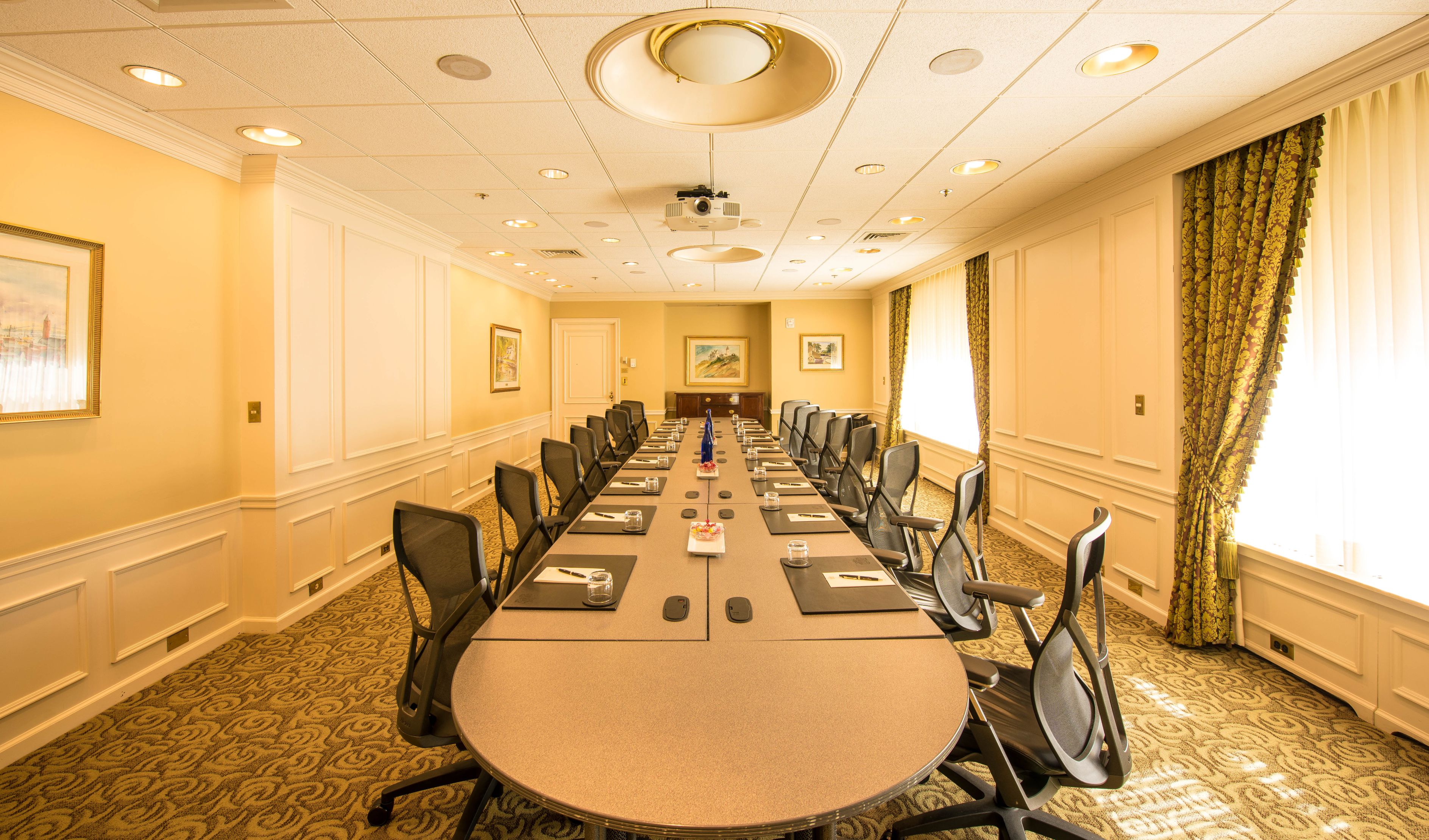a long conference table with chairs in a room