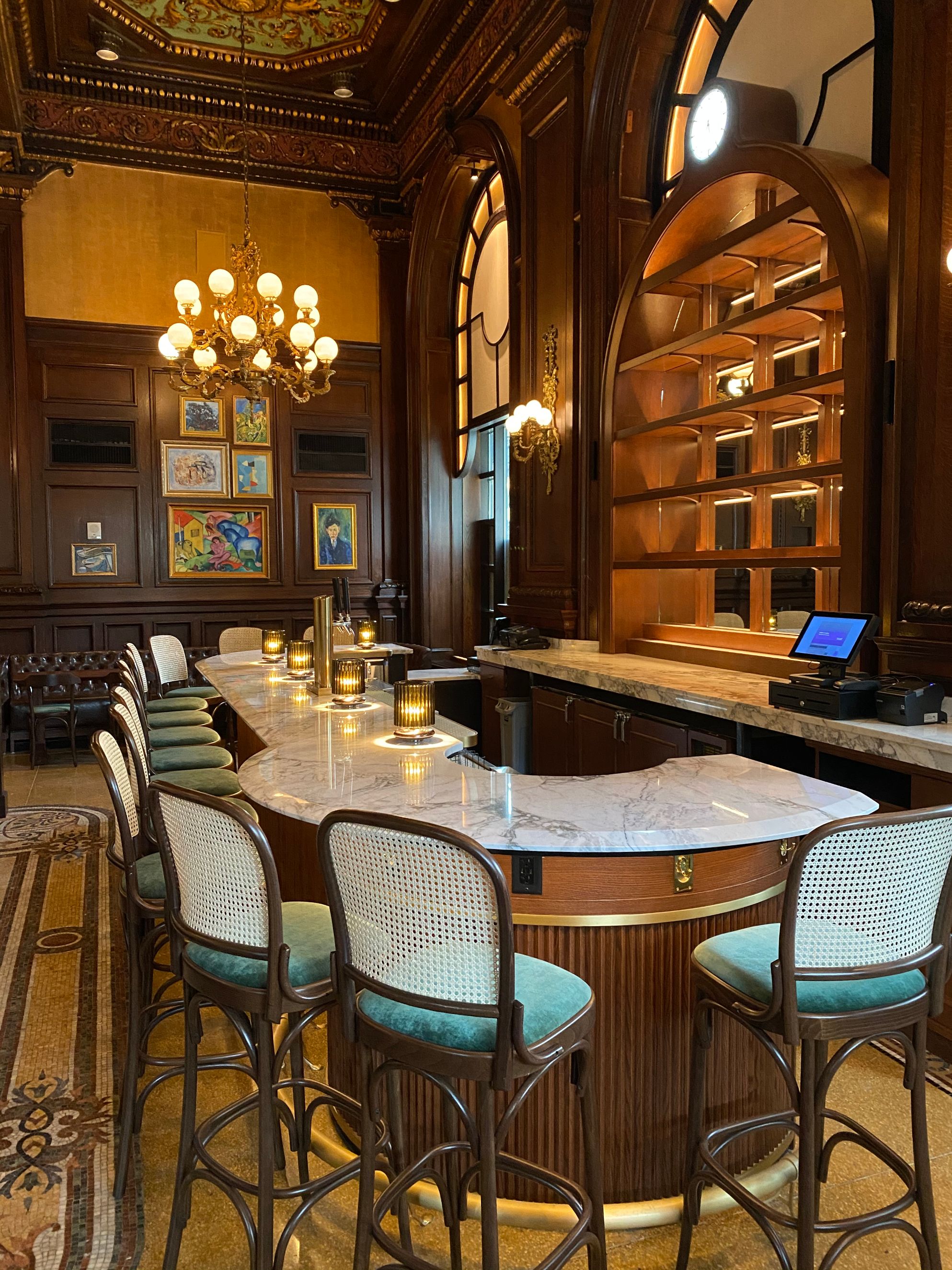 a room with a bar and chairs