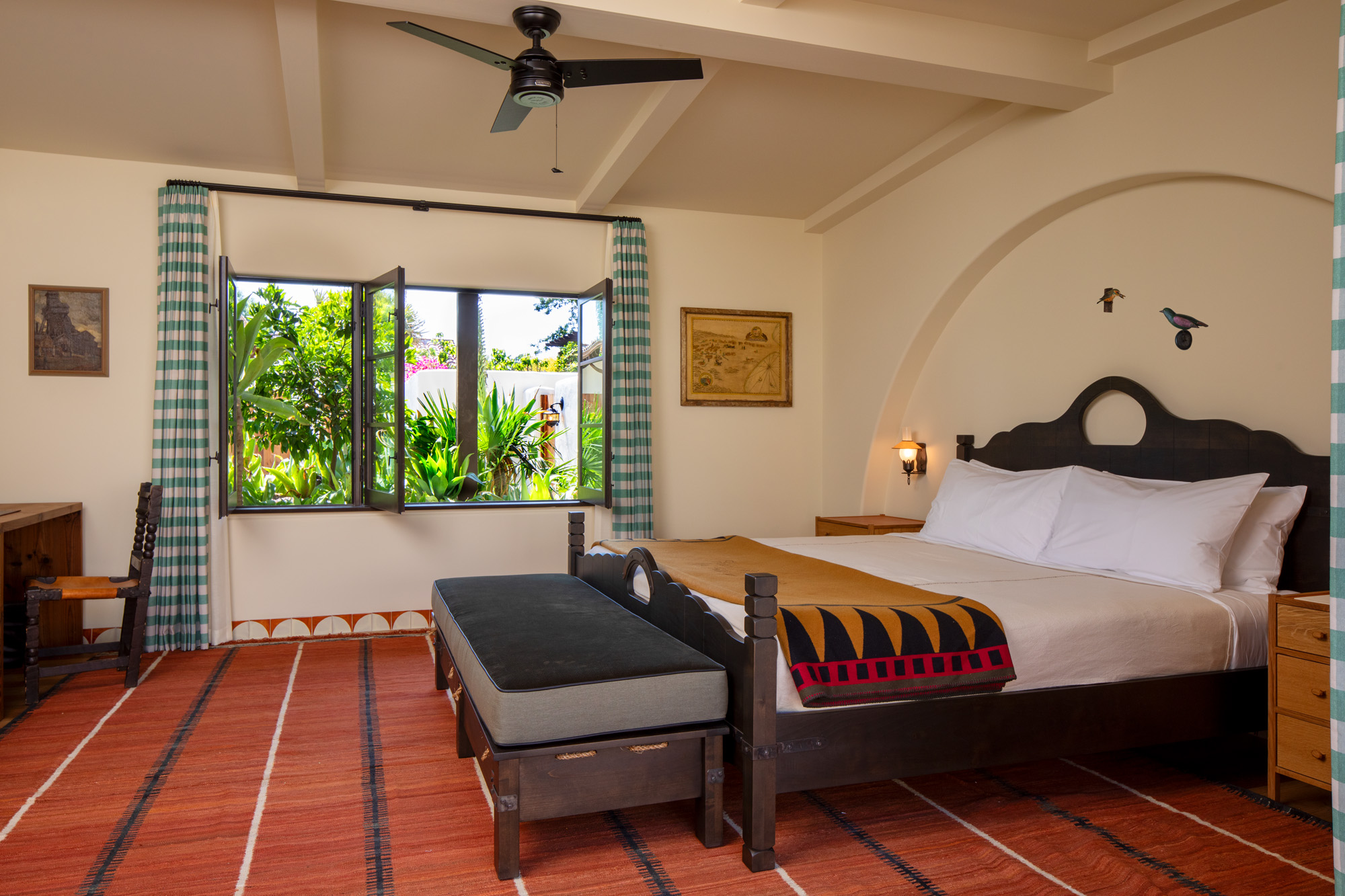 a room with a bed and a fan