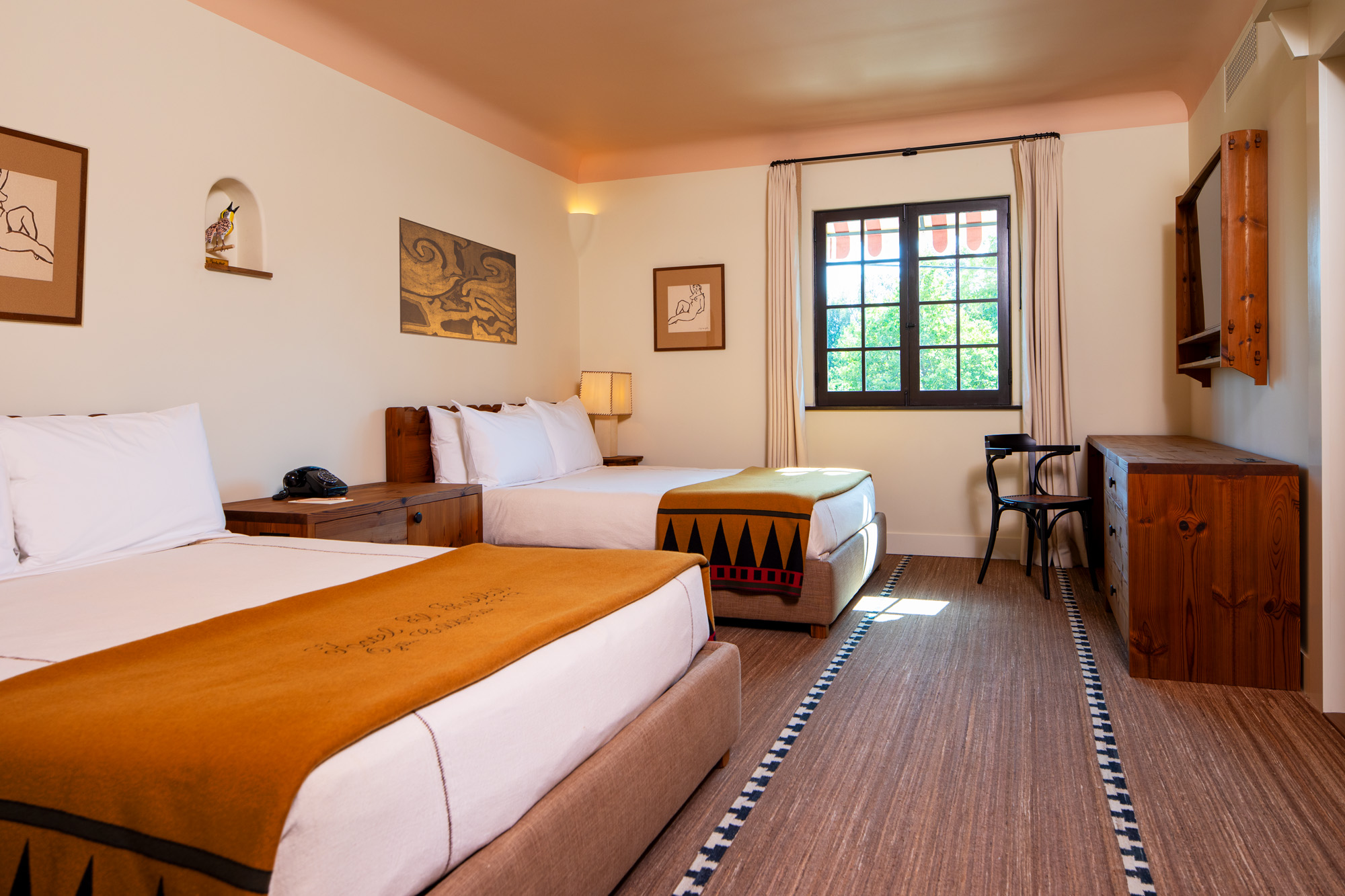 a room with two beds and a window