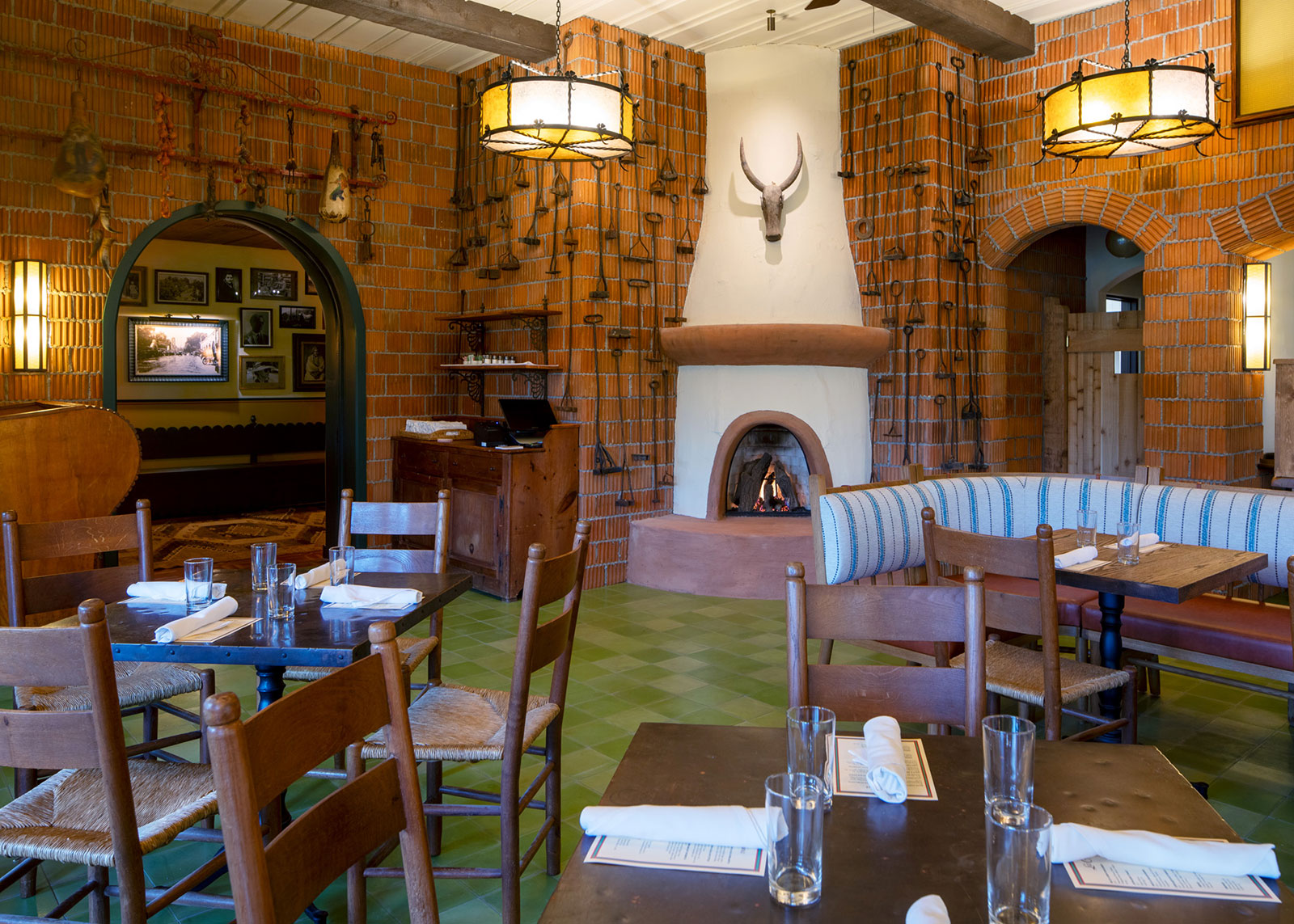 a room with tables and chairs and a fireplace