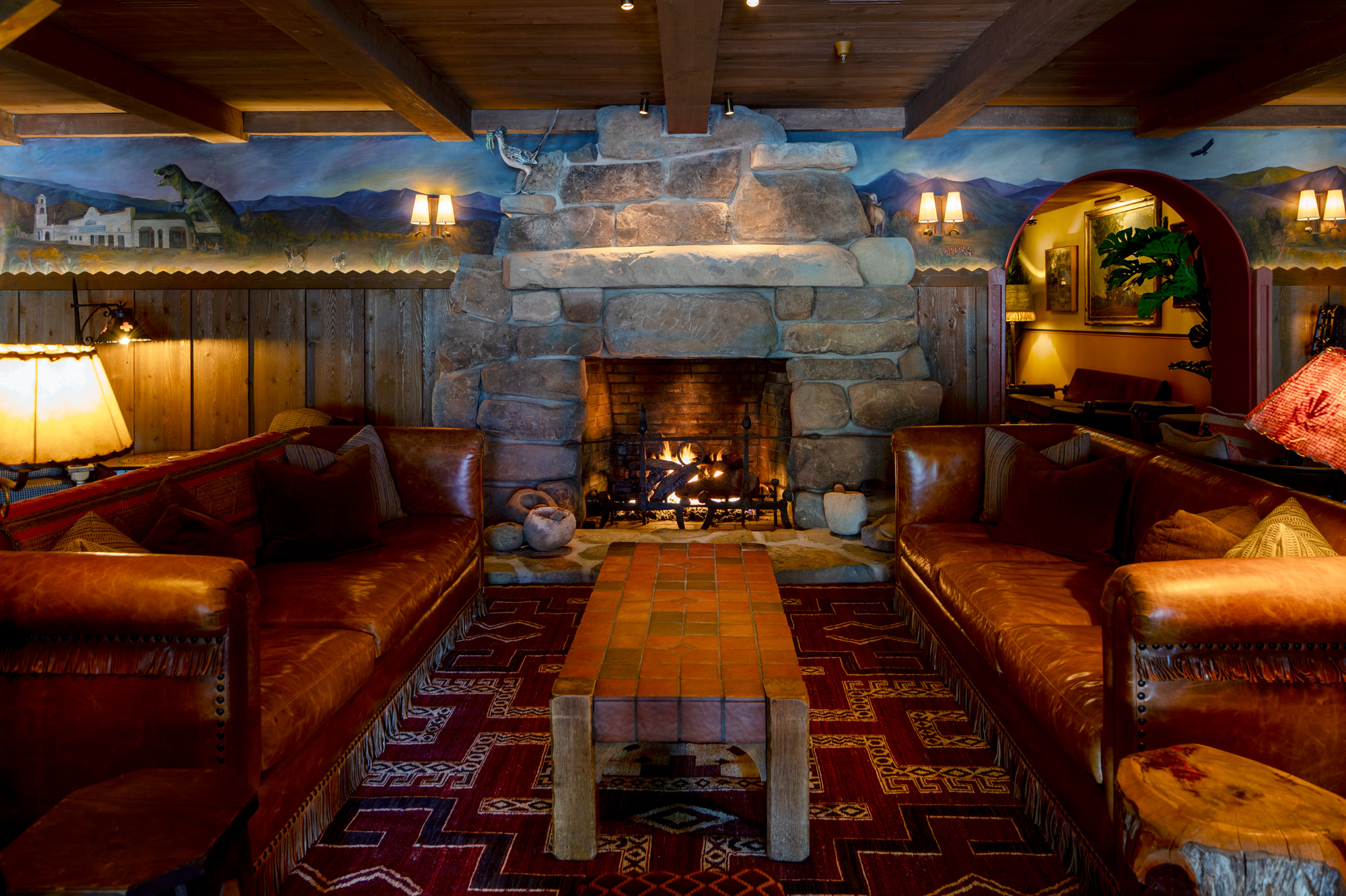 a room with a fireplace and couches