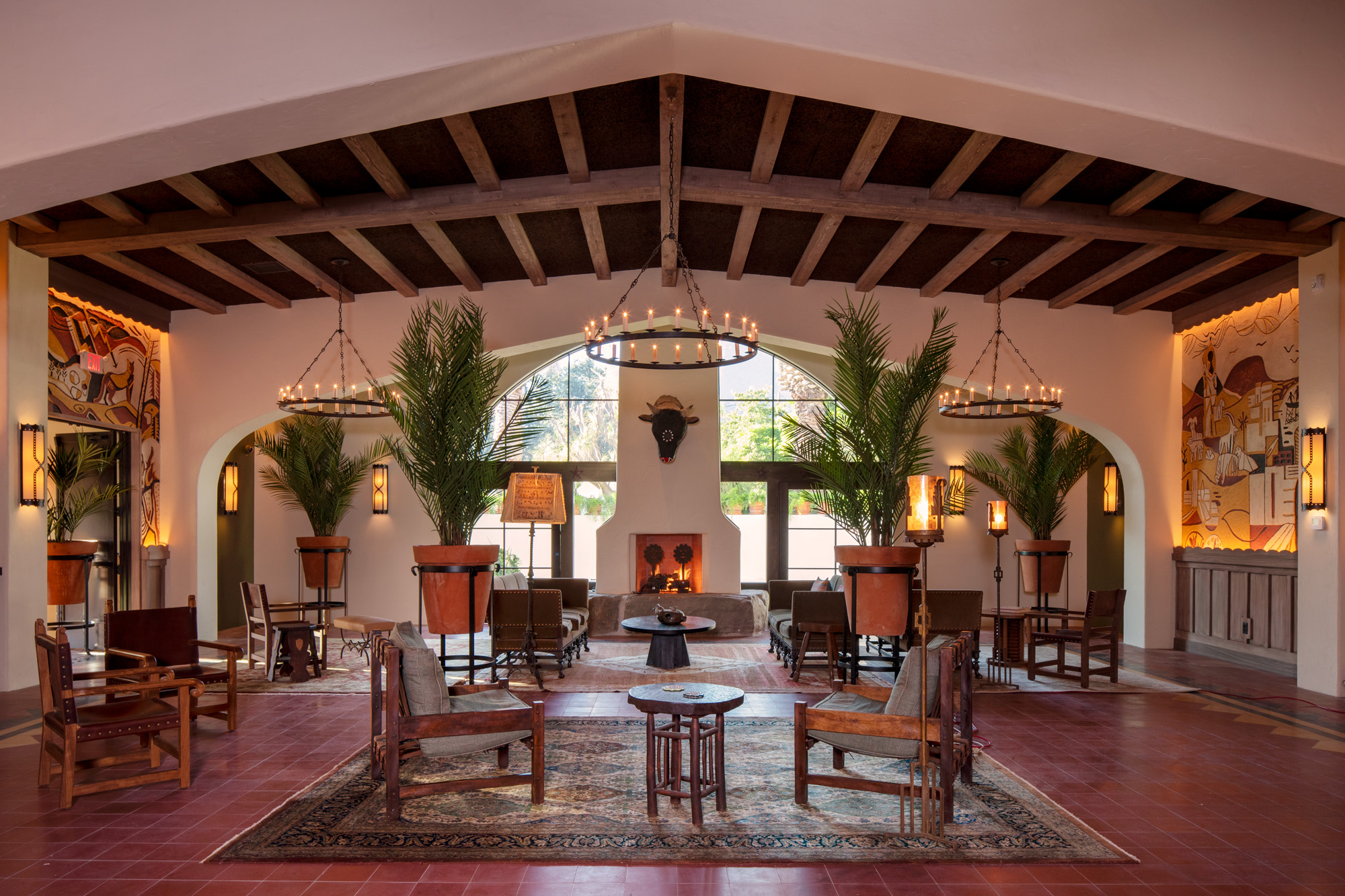 a room with chairs and tables and a fireplace