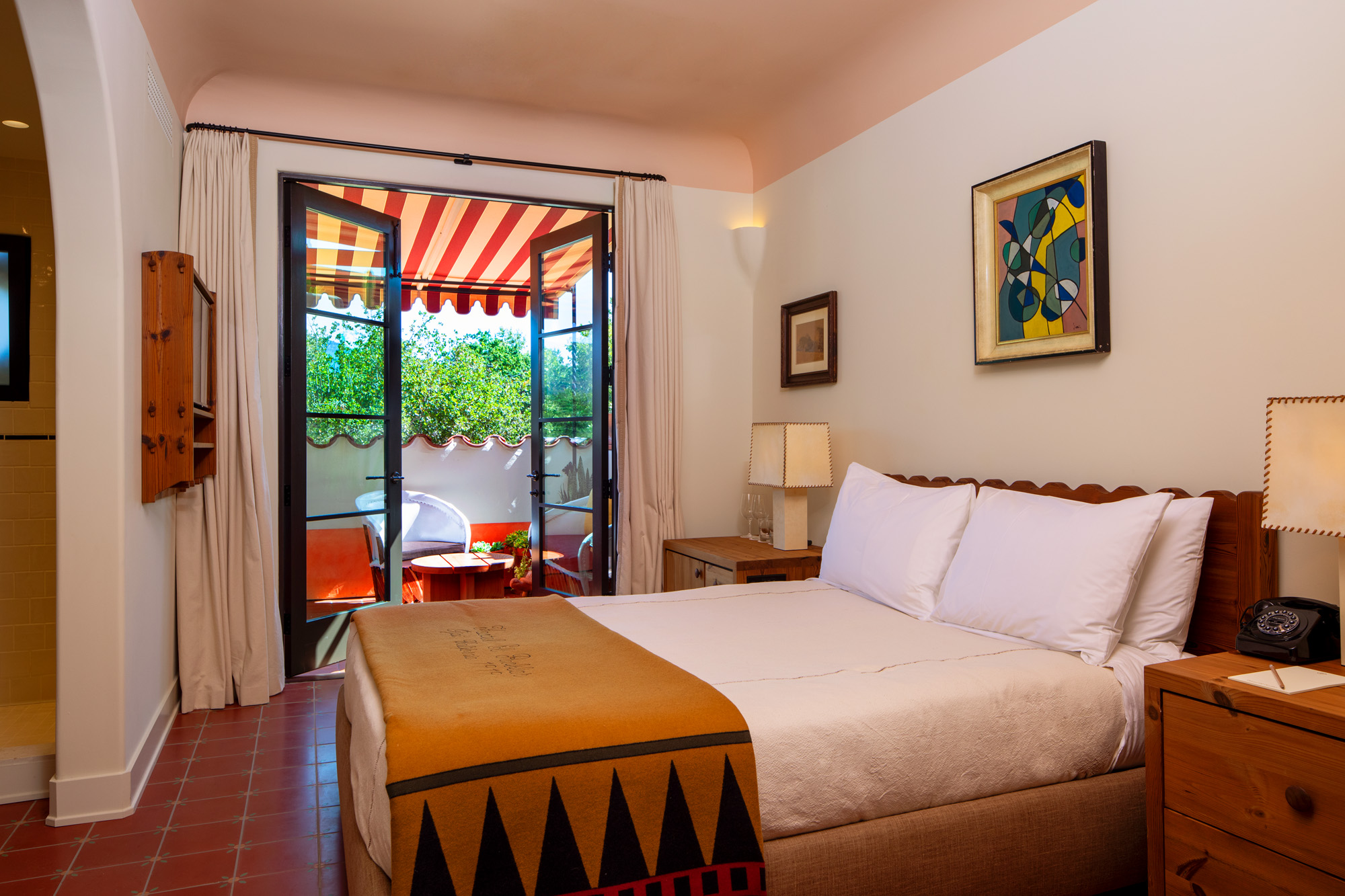 a bed with a door open to a patio