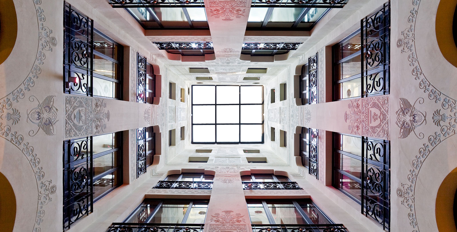 looking up at a building with a skylight