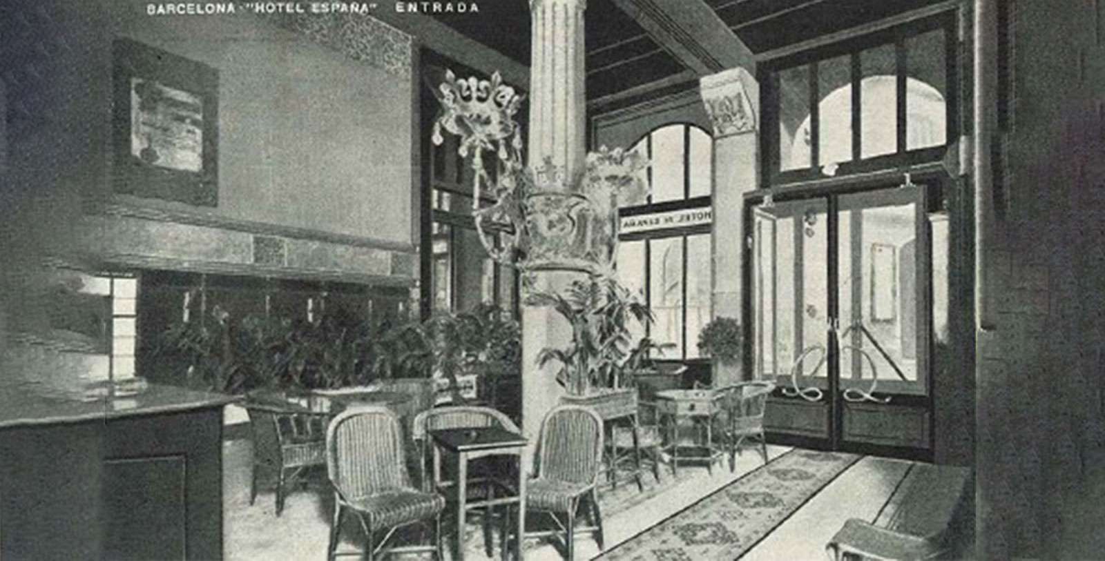 a black and white photo of a hotel lobby