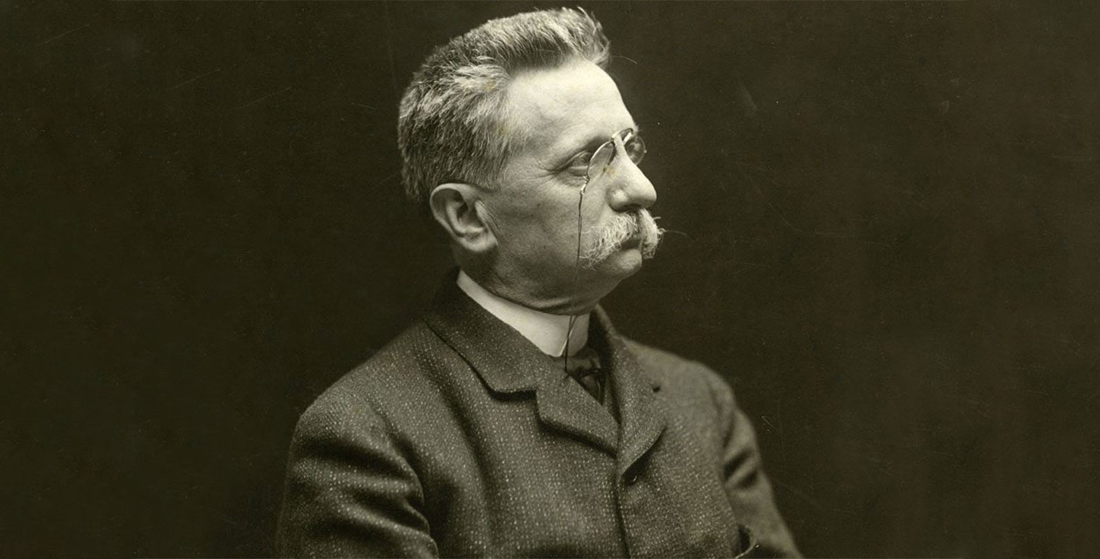 a man with a mustache and glasses