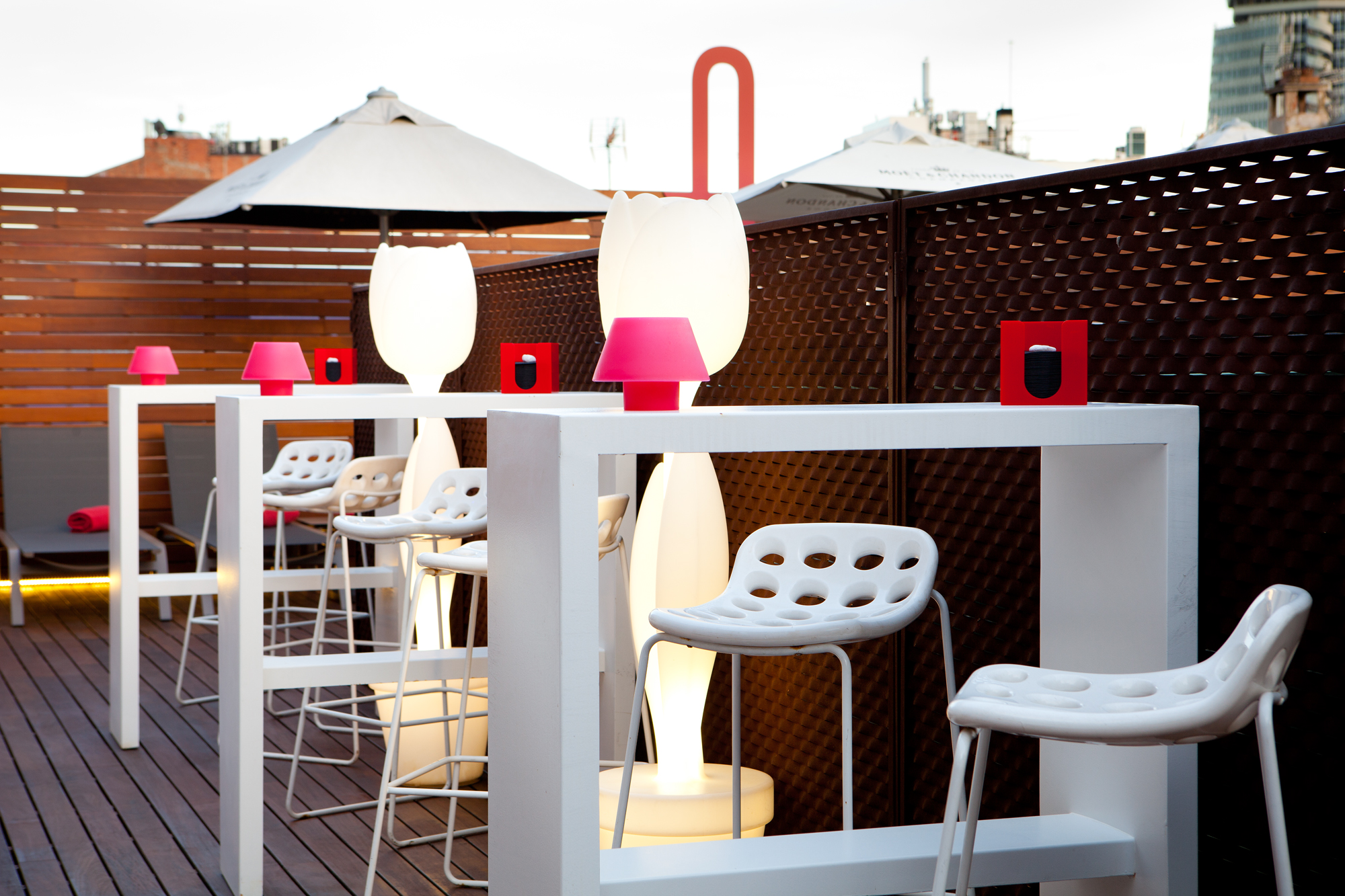 a group of white tables with pink lamps