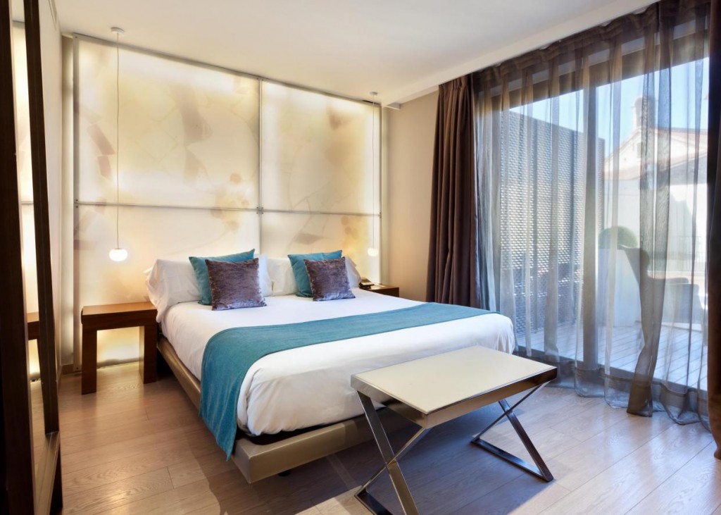 a bedroom with a bed and a table