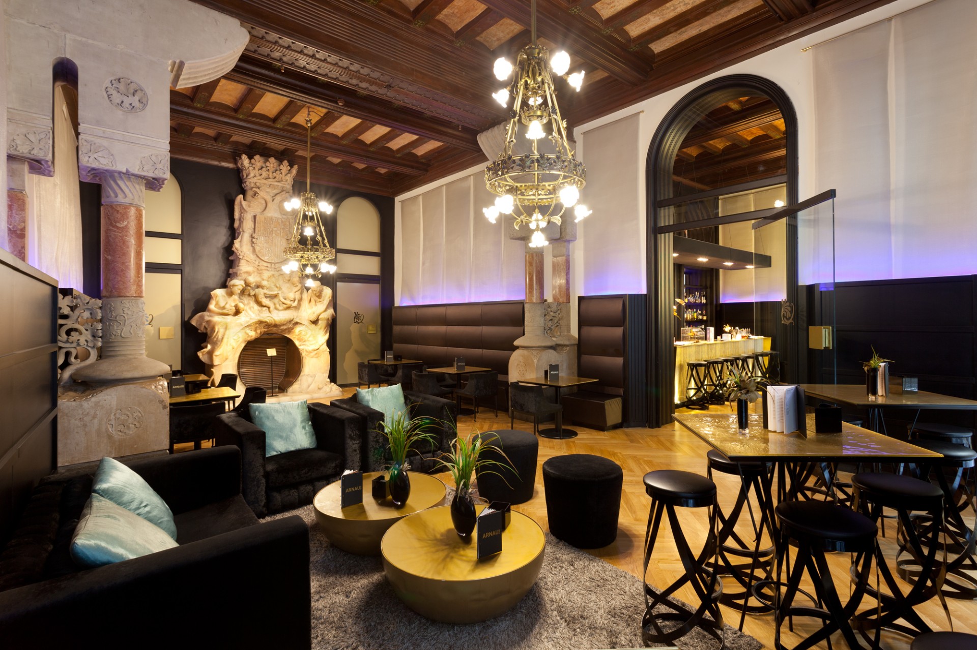 a room with a large chandelier and tables