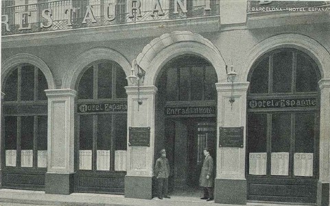a group of people standing outside of a restaurant