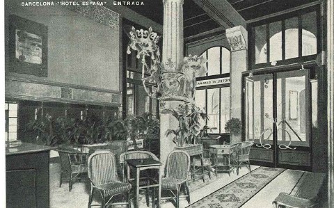 a black and white photo of a hotel lobby