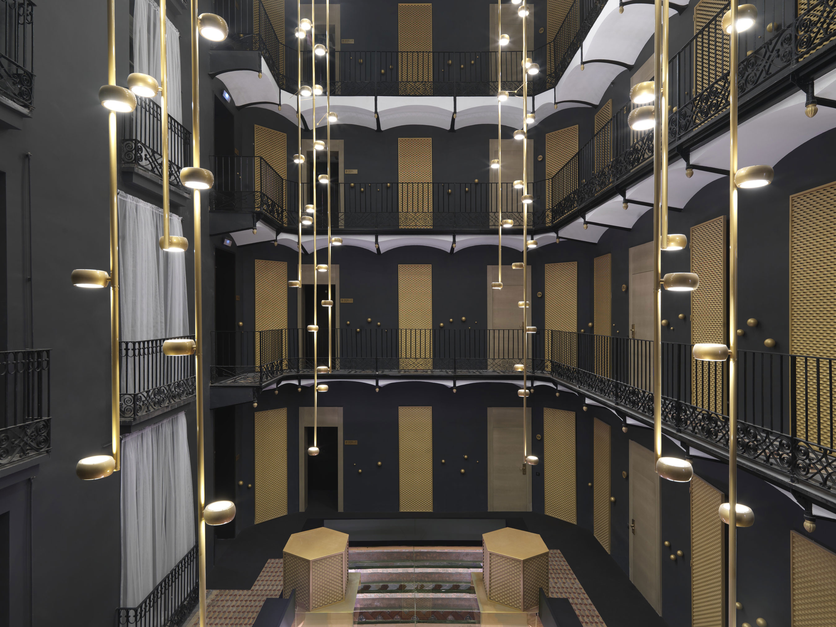 a room with a staircase and lights
