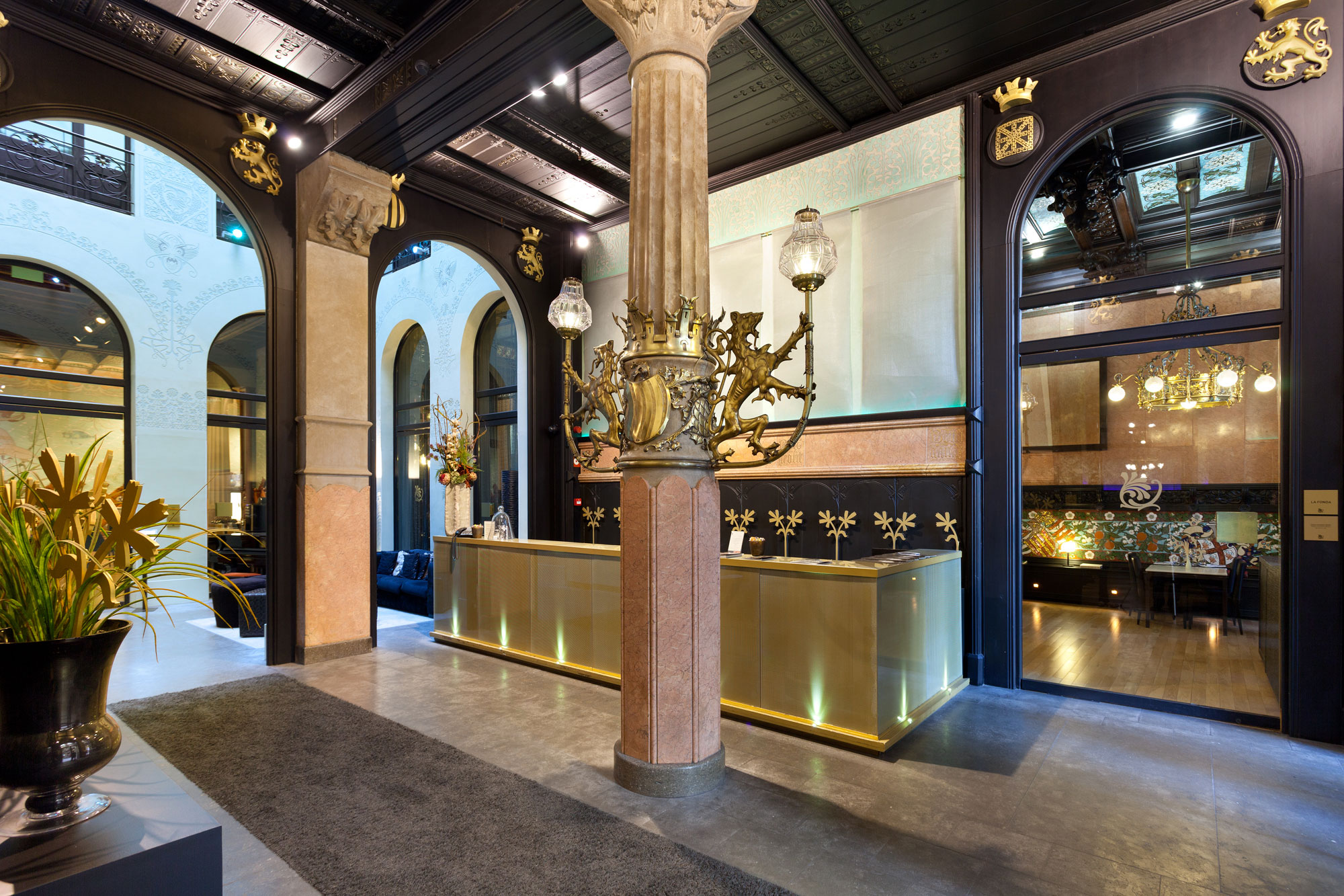 a lobby with a large pillar and a reception desk